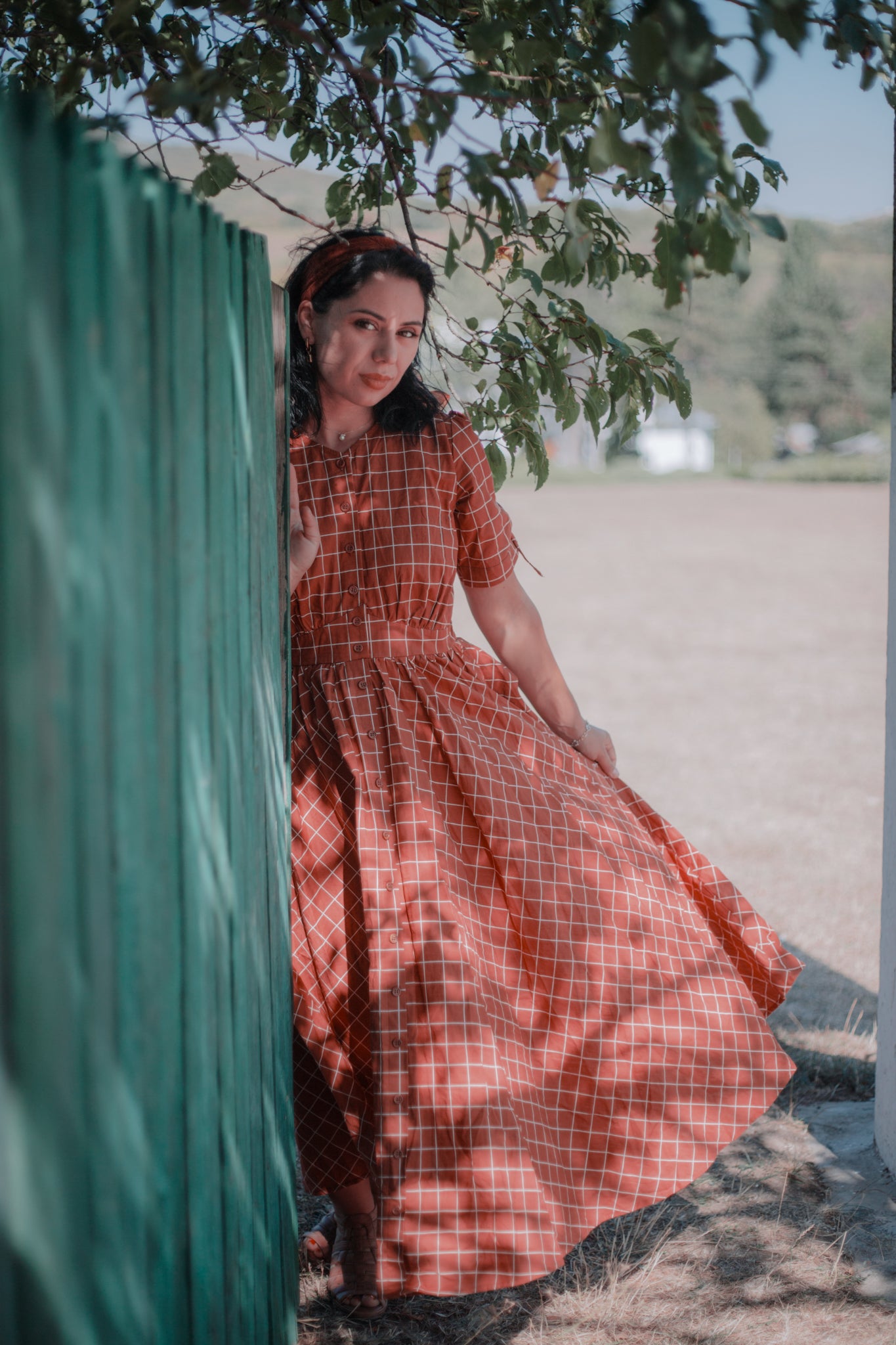 Woman in modest nursing checkered dress outdoors