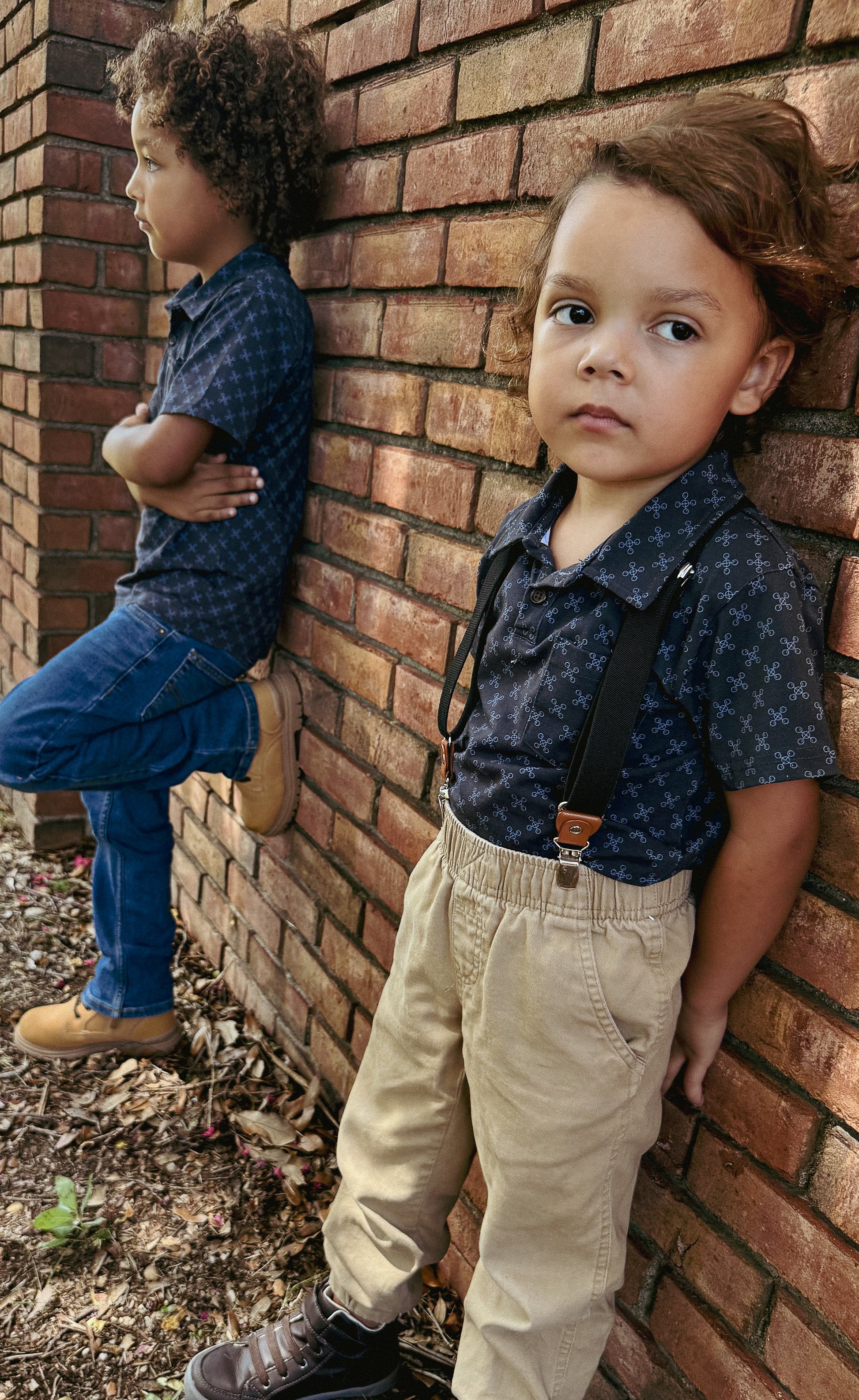 Young boys wearing dark blue polo shirts