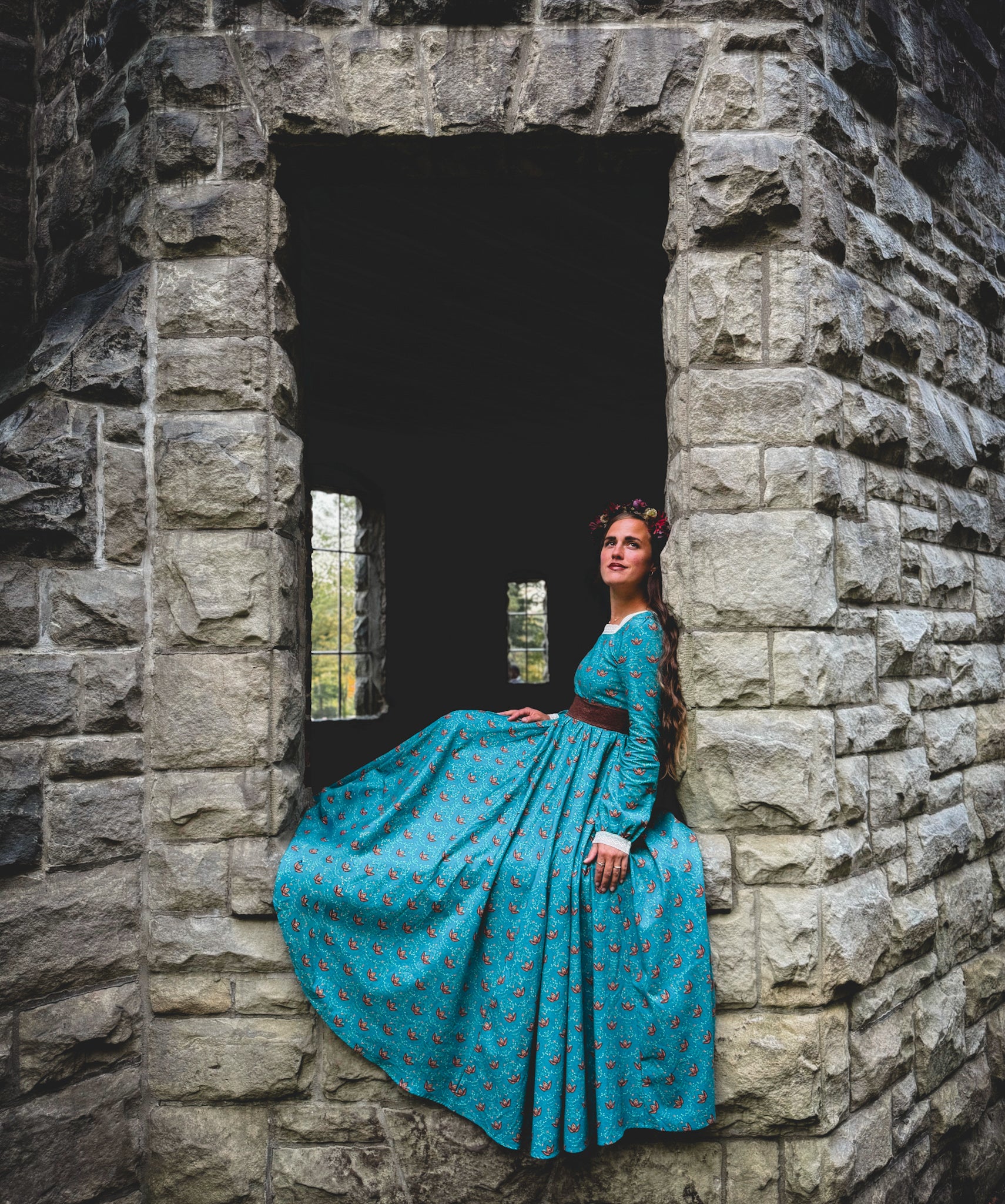 Woman in modest nursing blue dress in archway