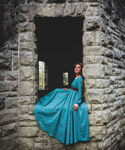 Woman in modest nursing blue dress in archway