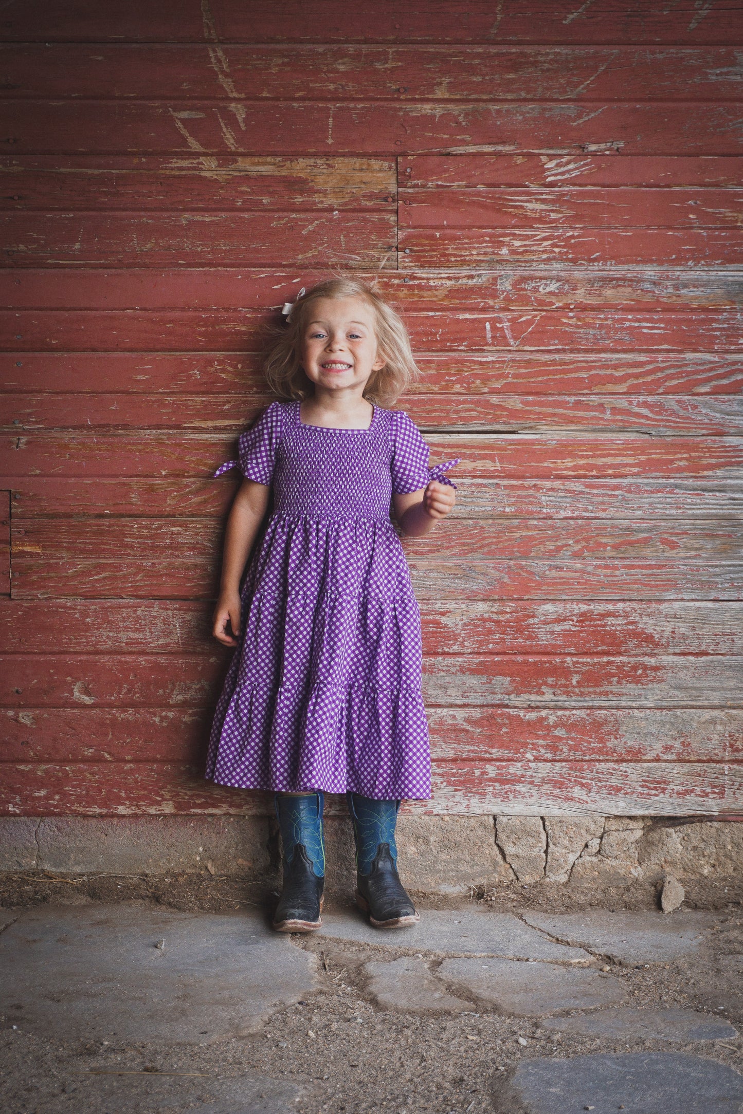 Young girl wearing a modest purple dress