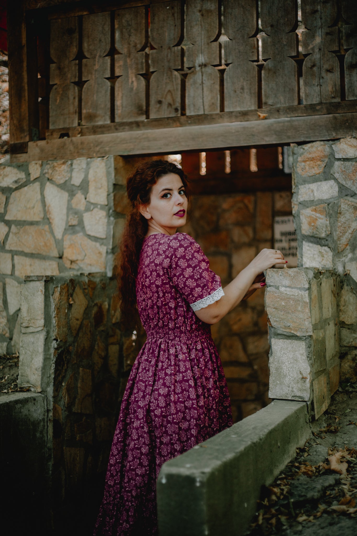 Woman in modest purple nursing dress outdoors