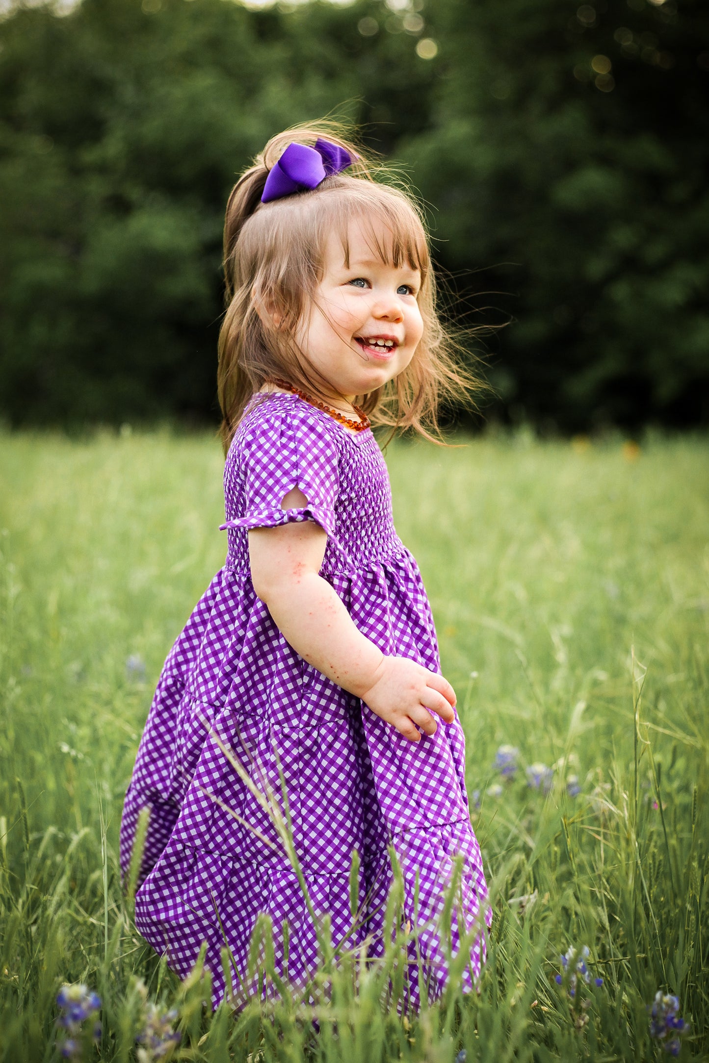Young girl wearing a modest purple dress
