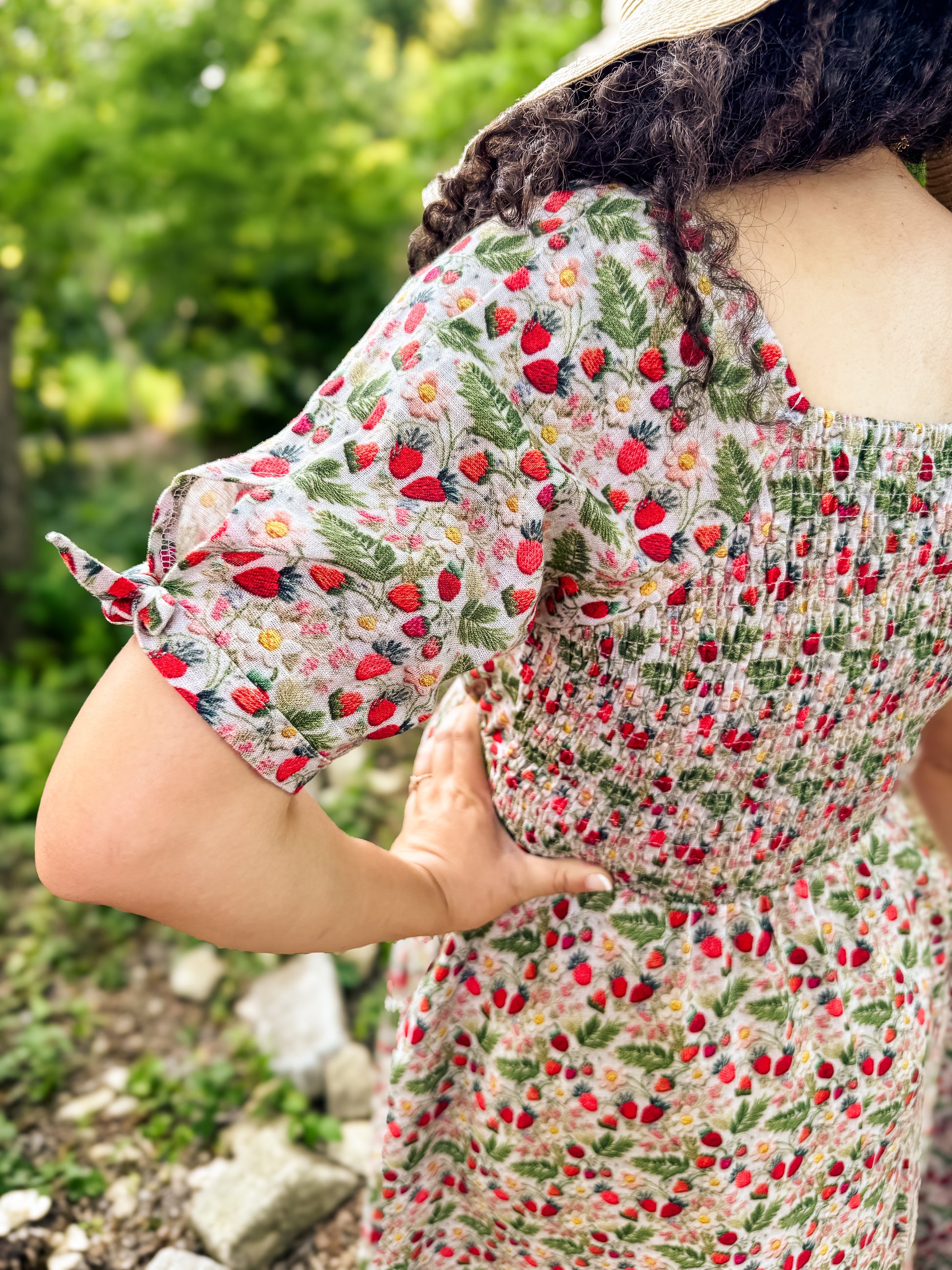 Person wearing a floral modest nursing dress with a blurred natural background