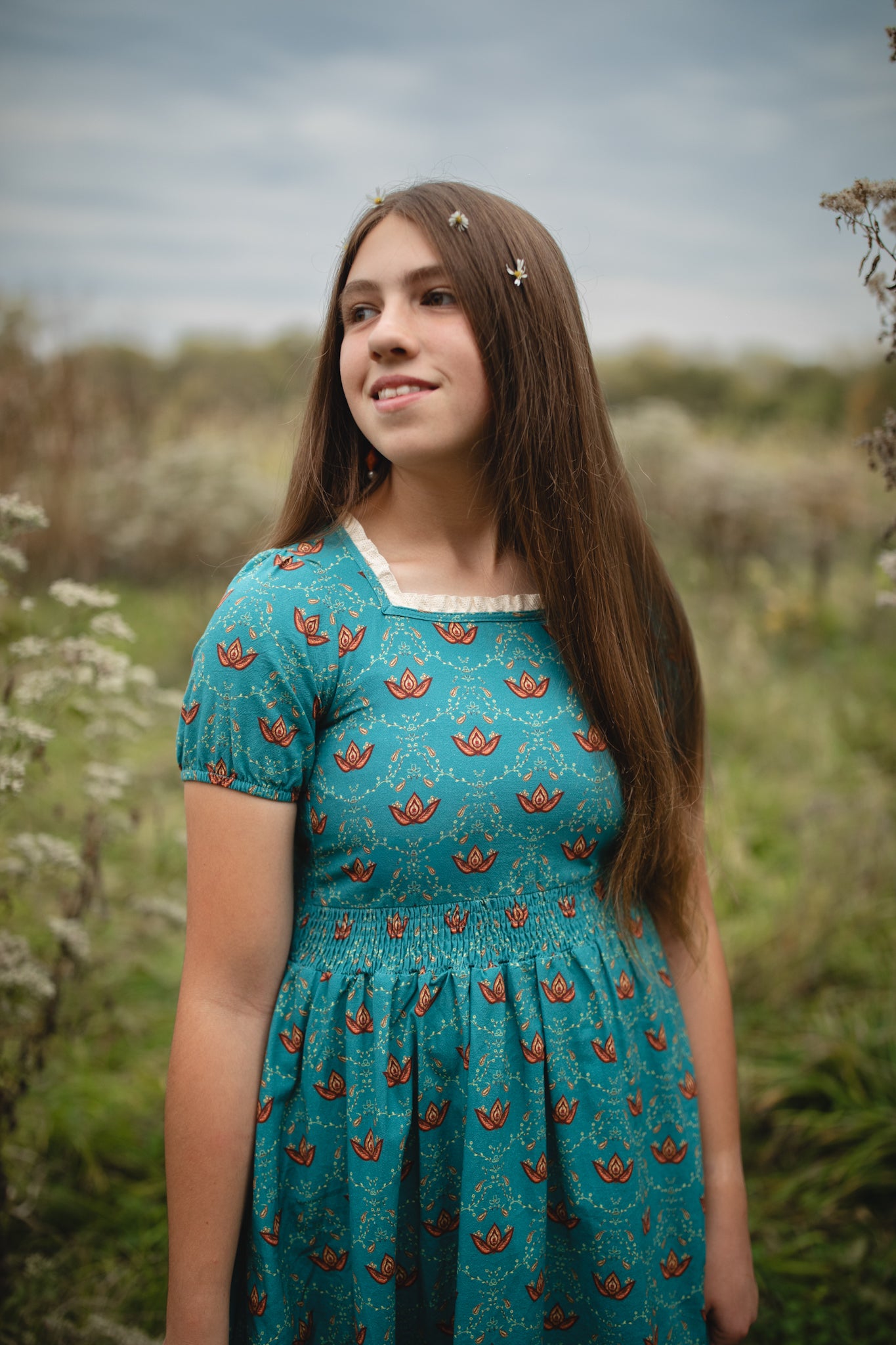 Young woman wearing modest nursing dress with patterns.