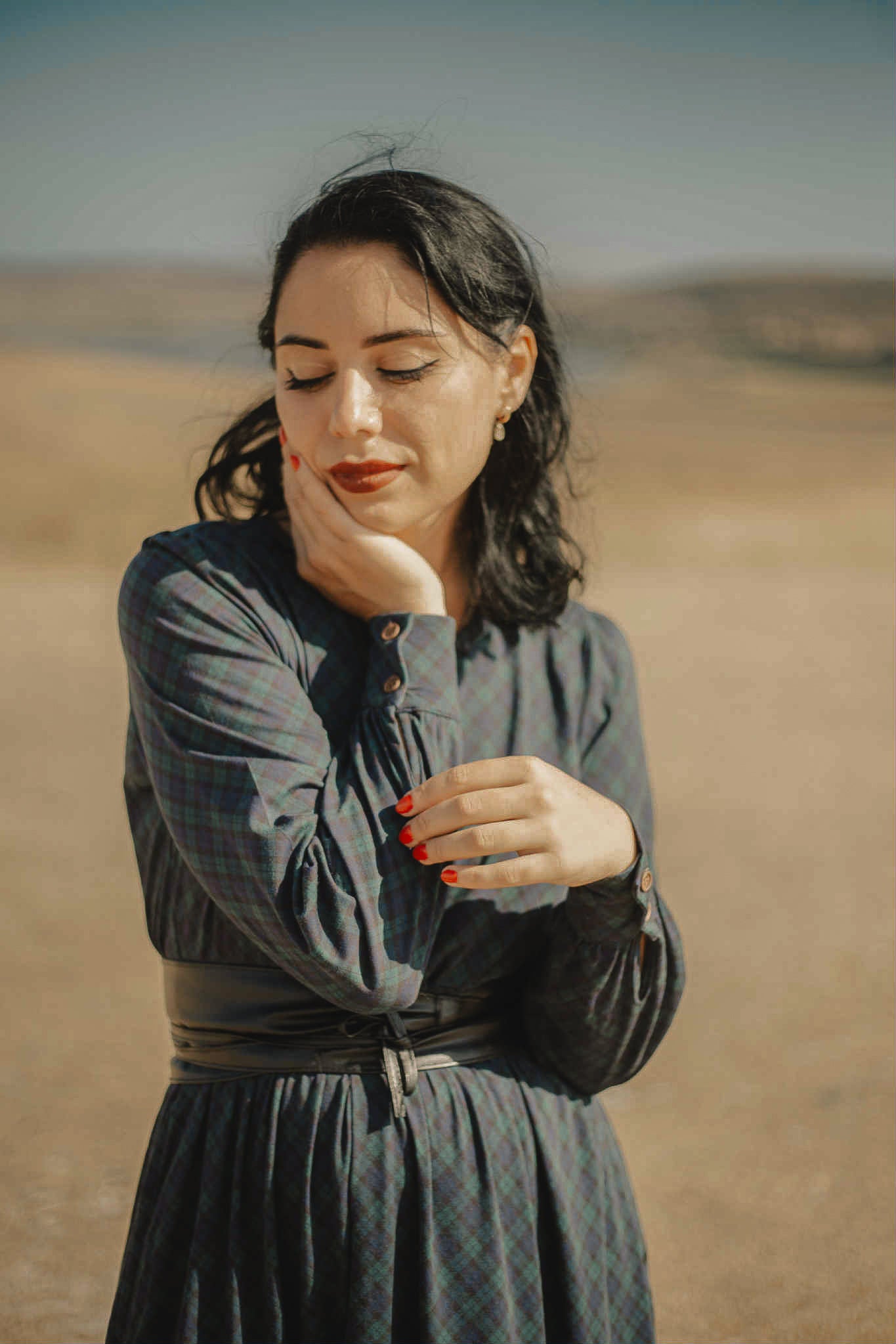 Woman in modest nursing dress desert landscape