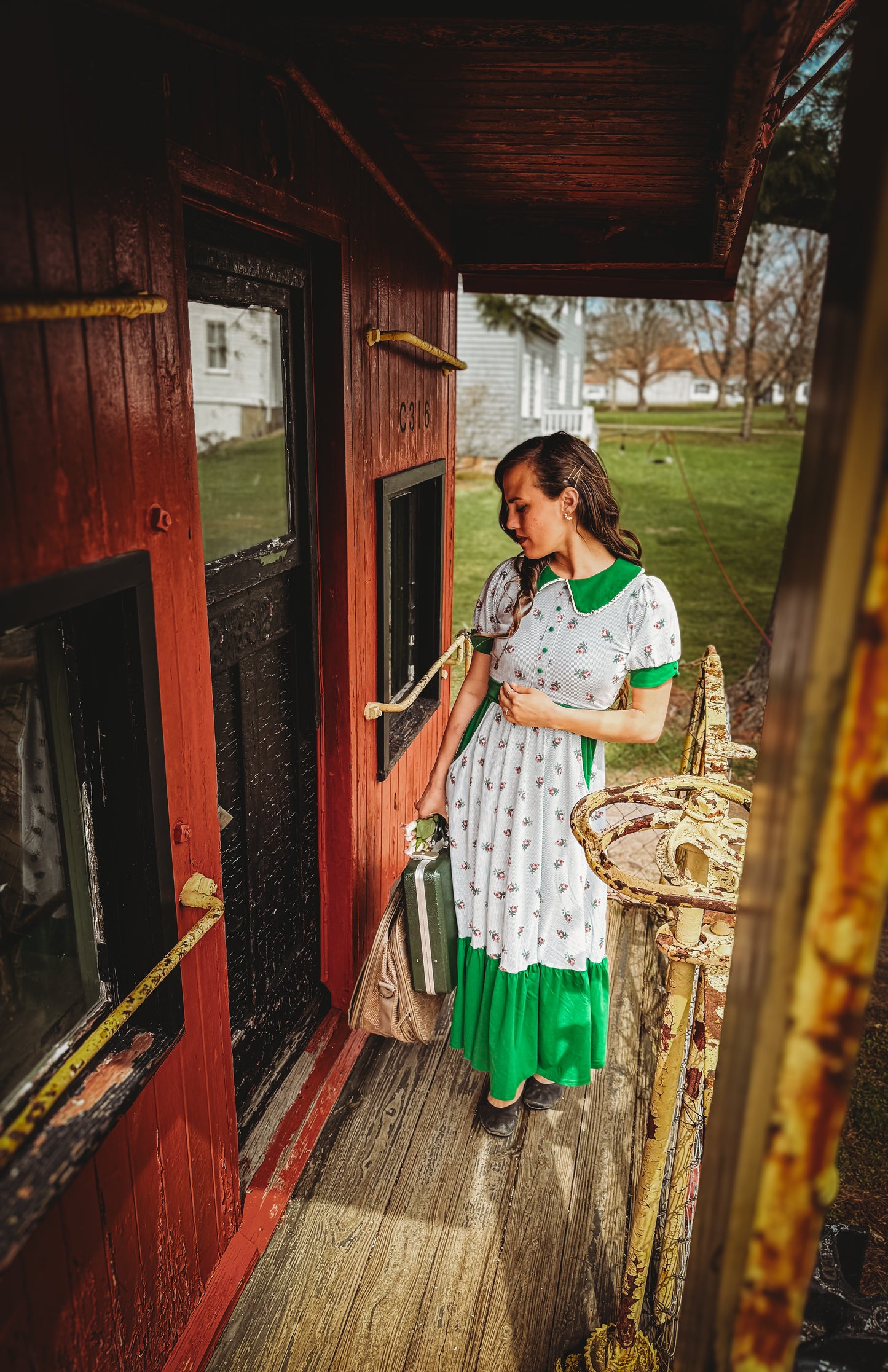 woman wearing a green and white striped modest nursing dress