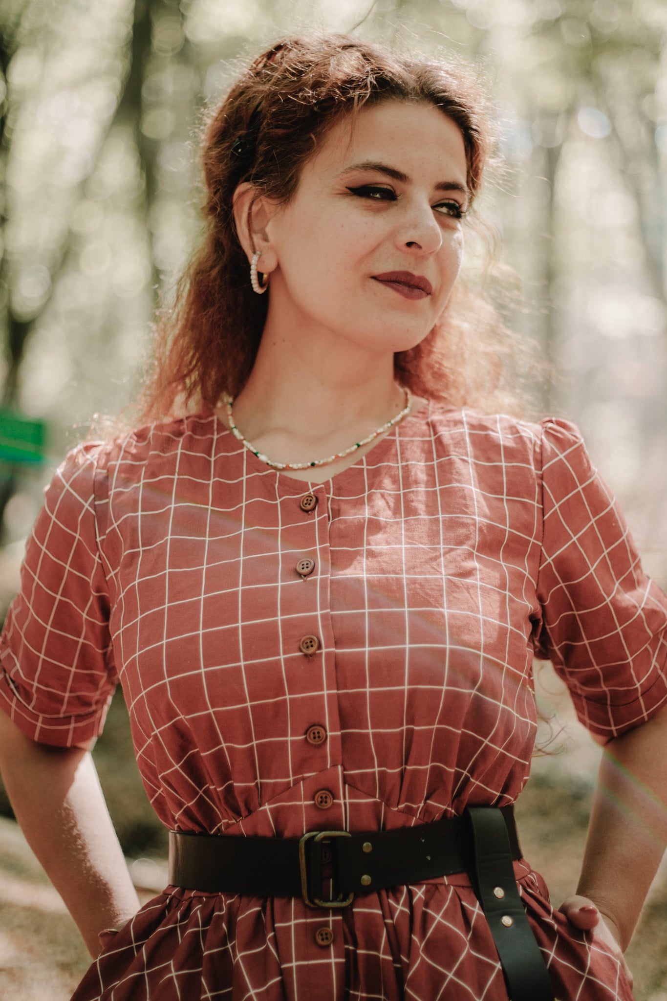 Woman in modest nursing checkered dress outdoors