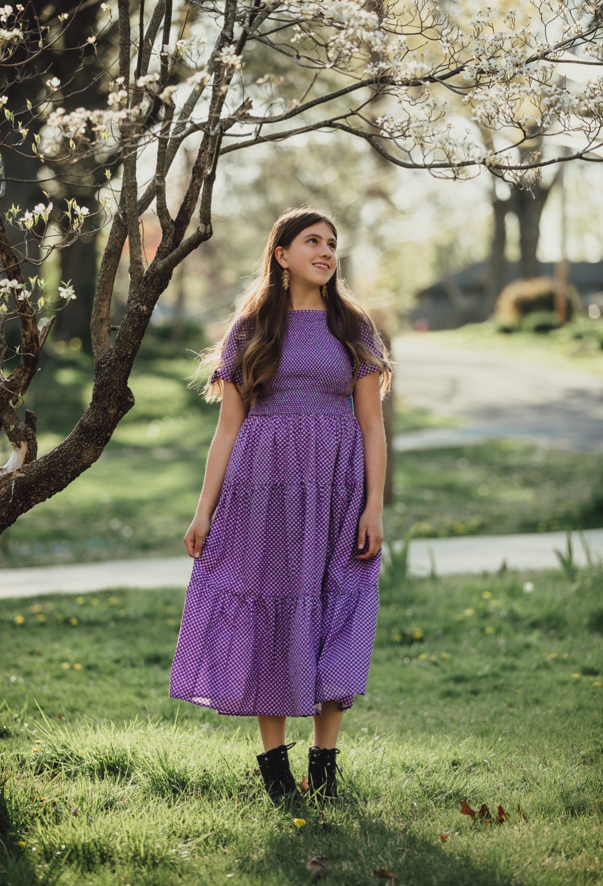 Young girl wearing a modest purple dress