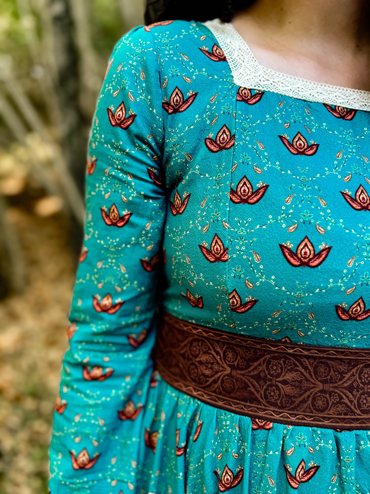 Woman in modest nursing teal dress with belt