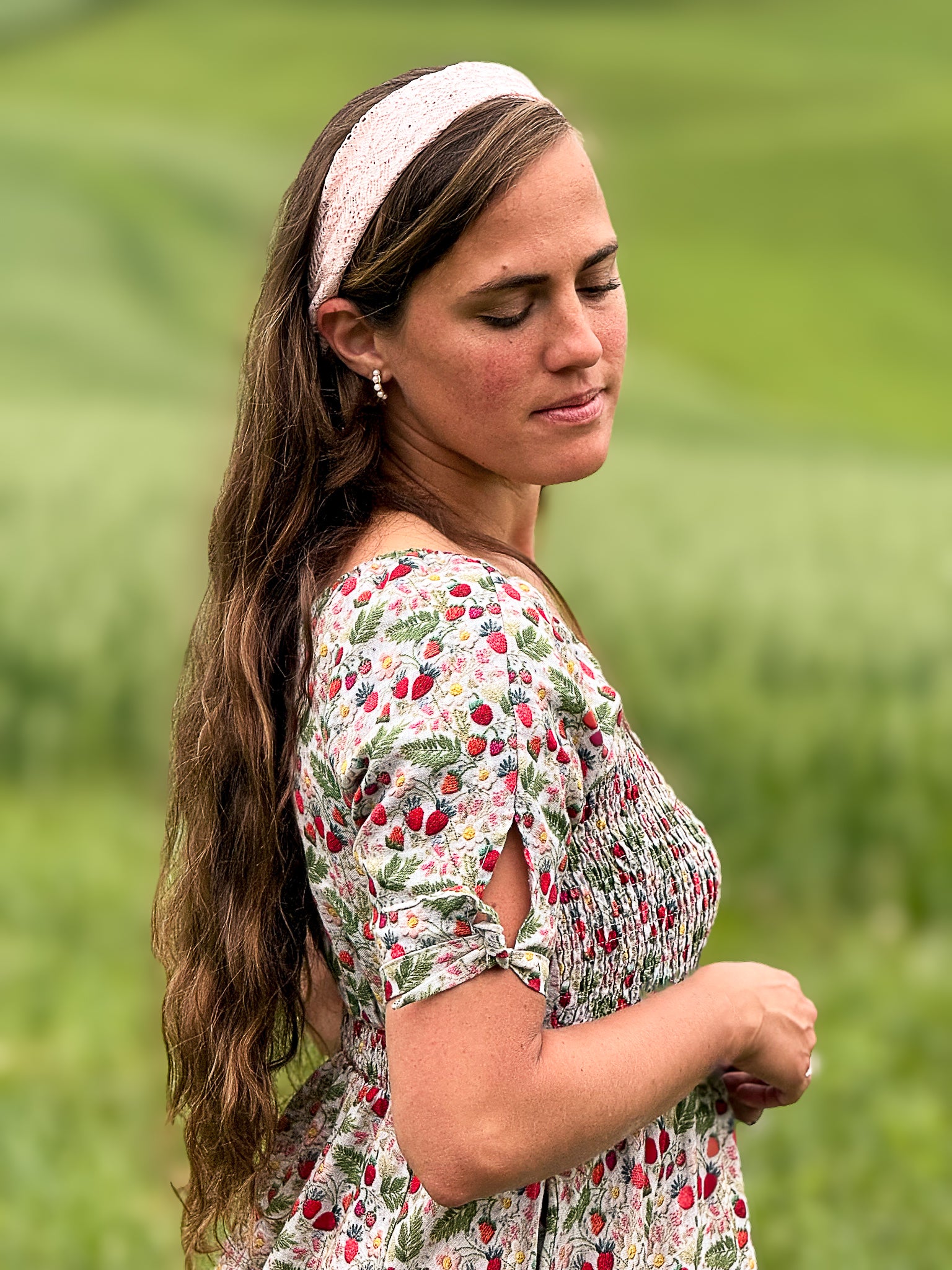 Woman in a floral modest nursing dress standing in a field