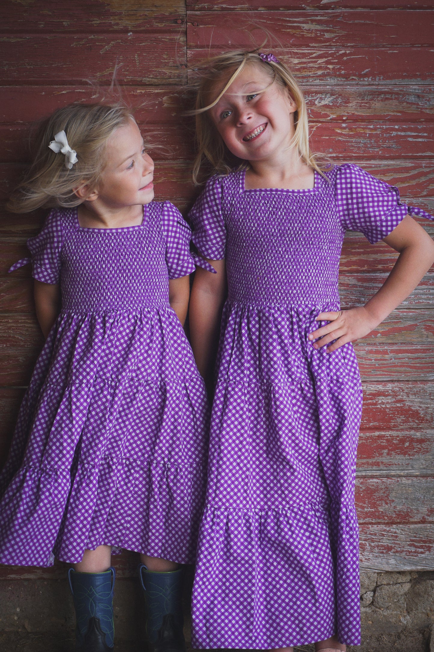 Young girls wearing modest purple dresses