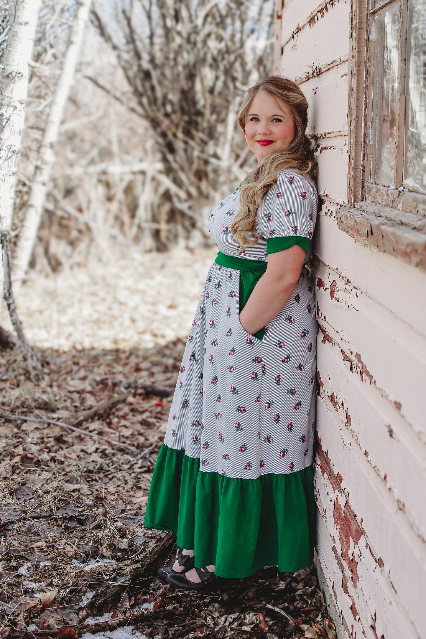 woman wearing a green and white striped modest nursing dress
