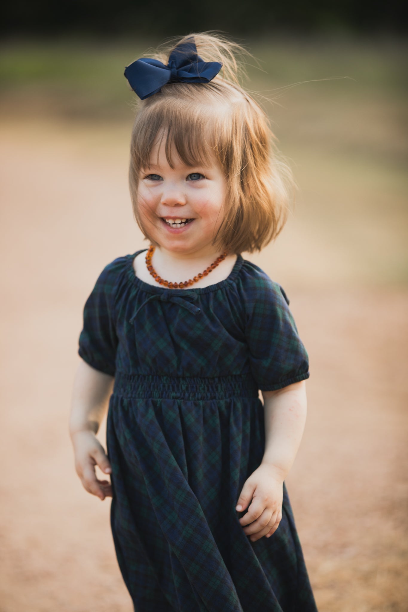 Girl in modest plaid dress outdoors