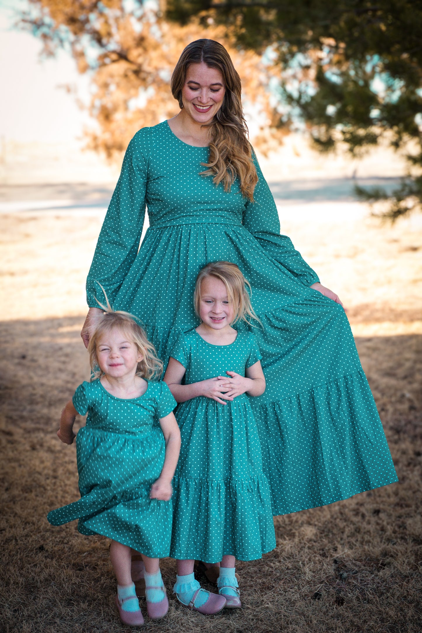 woman wearing modest nursing dress with her daughters wearing matching dresses