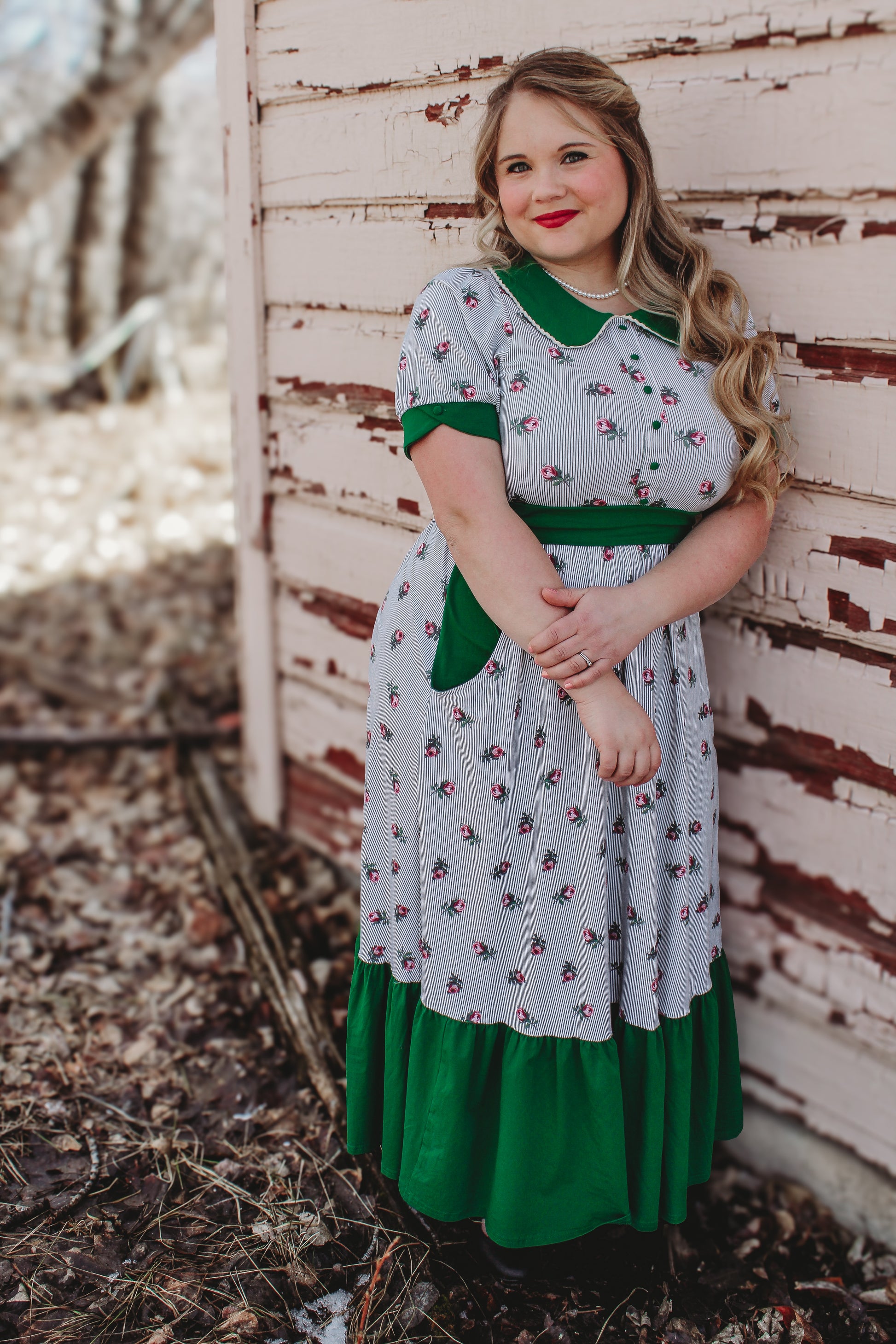woman wearing a green and white striped modest nursing dress
