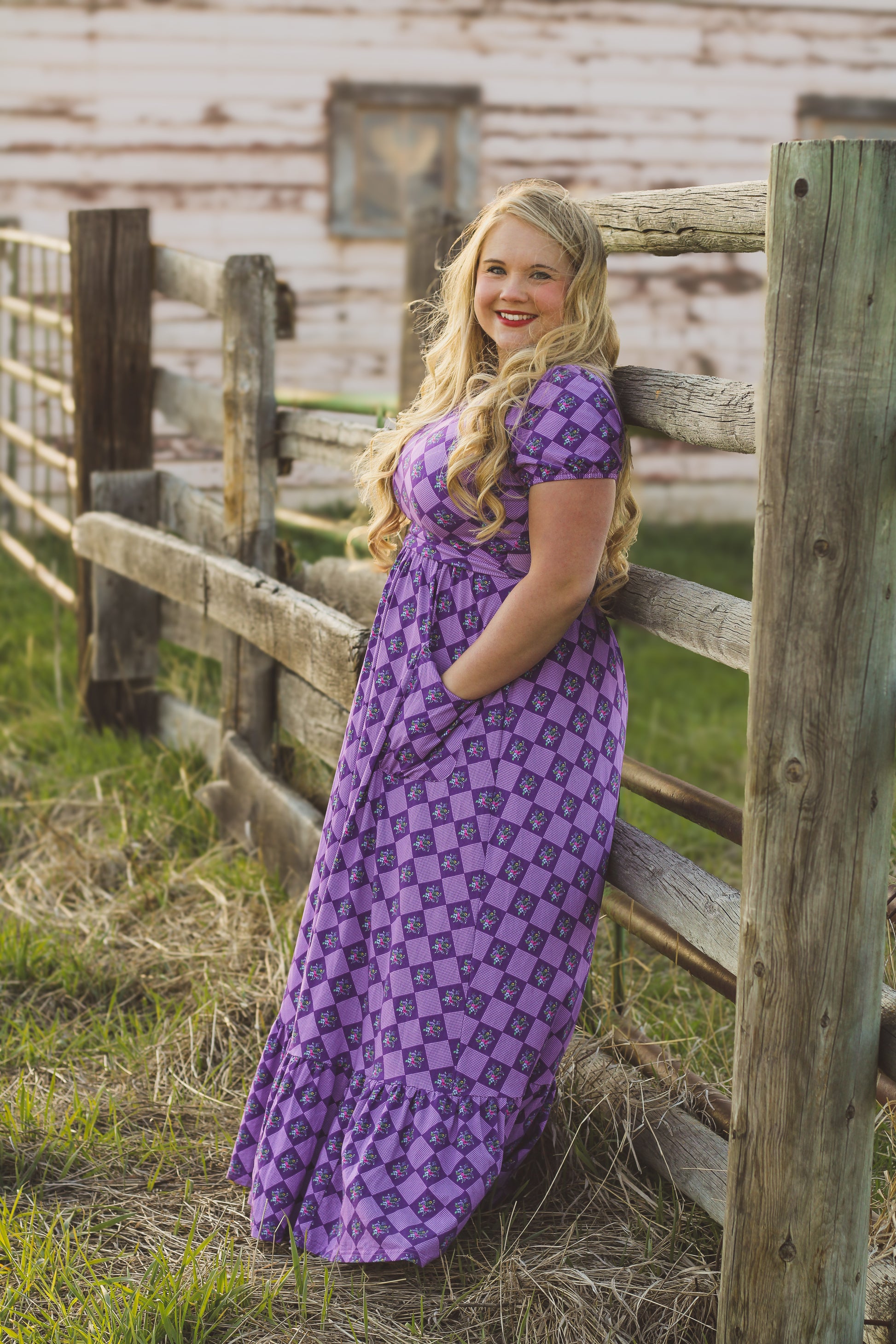 Woman in a purple checkered modest nursing dress.