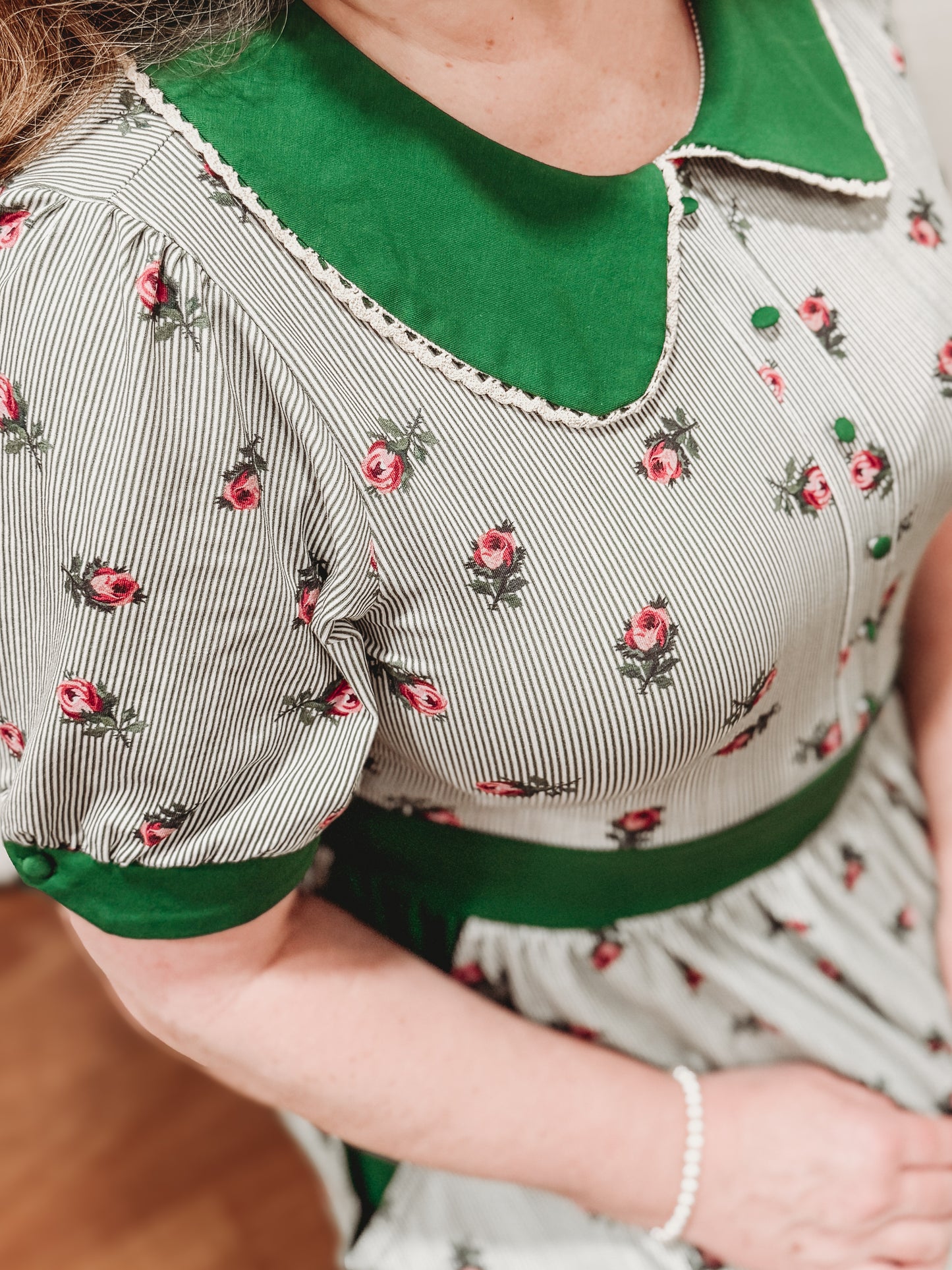 woman wearing a green and white striped modest nursing dress