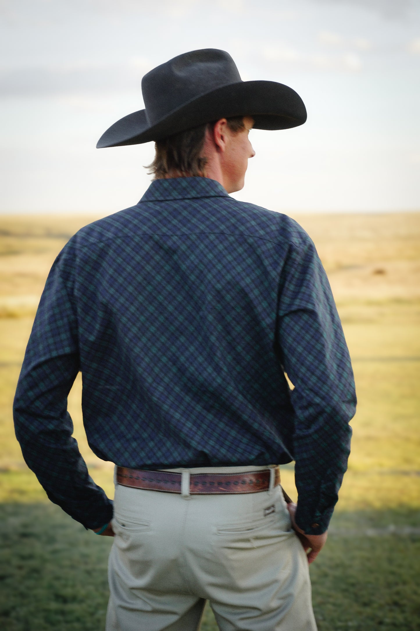 Man in plaid shirt and cowboy hat