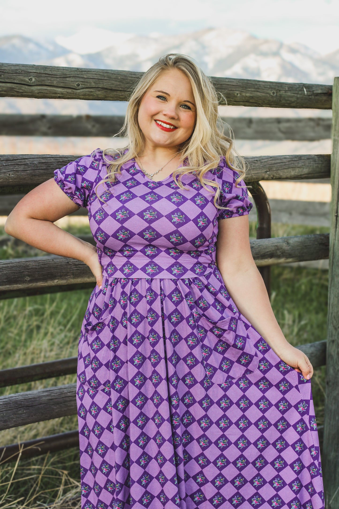 Woman in a purple checkered modest nursing dress.