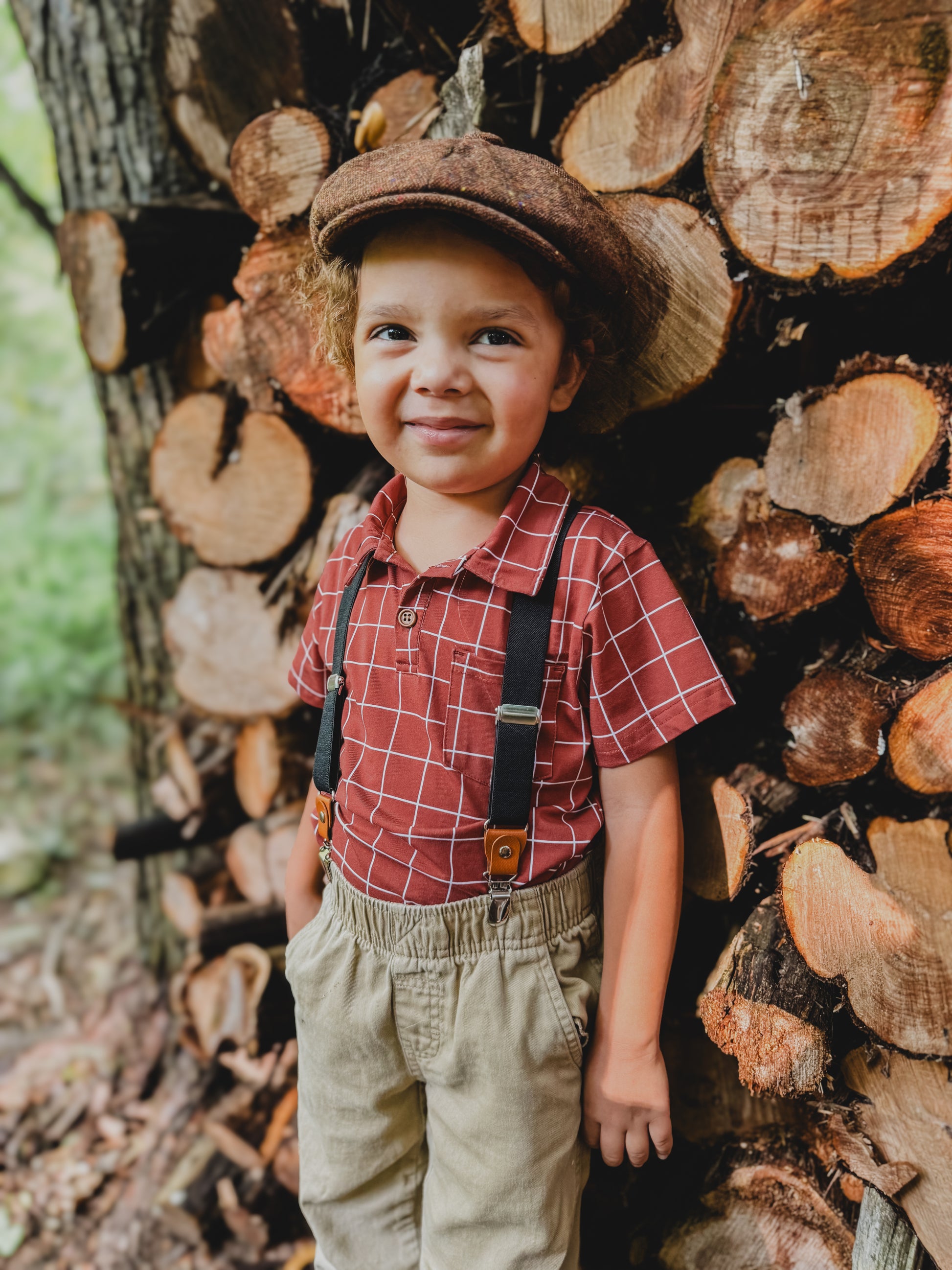Boy in plaid polo and suspenders