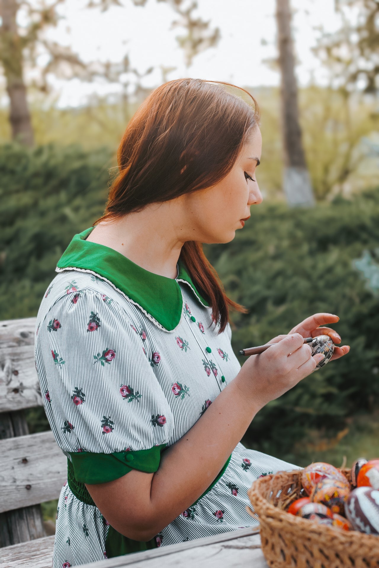 woman wearing a green and white striped modest nursing dress