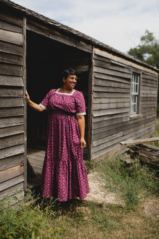 Woman in modest nursing dress with purple floral print