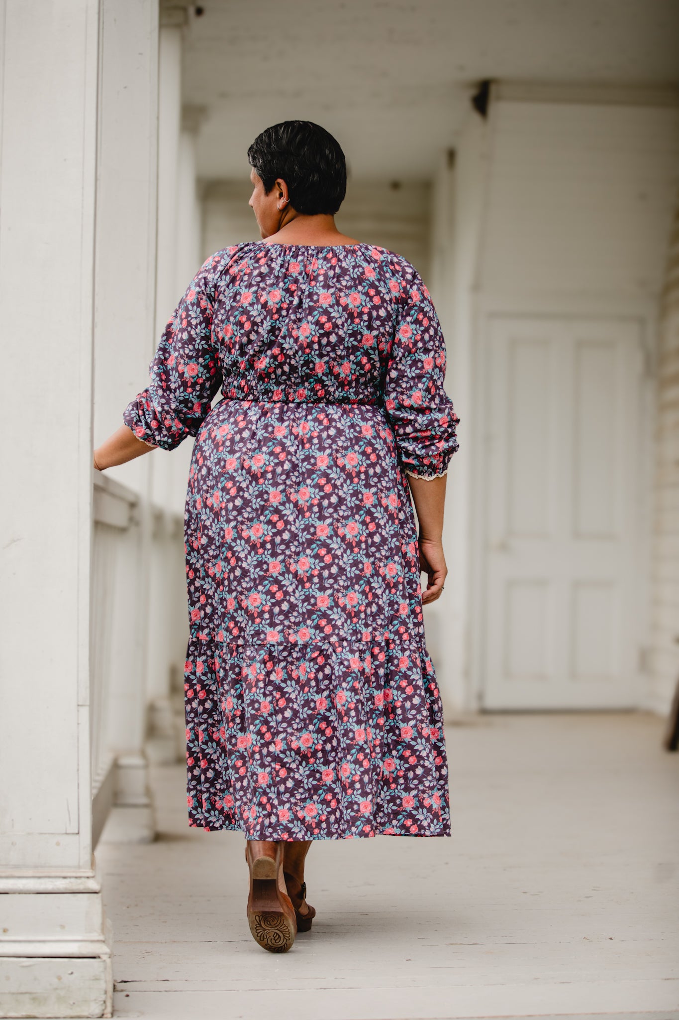 Woman in modest nursing dress on porch