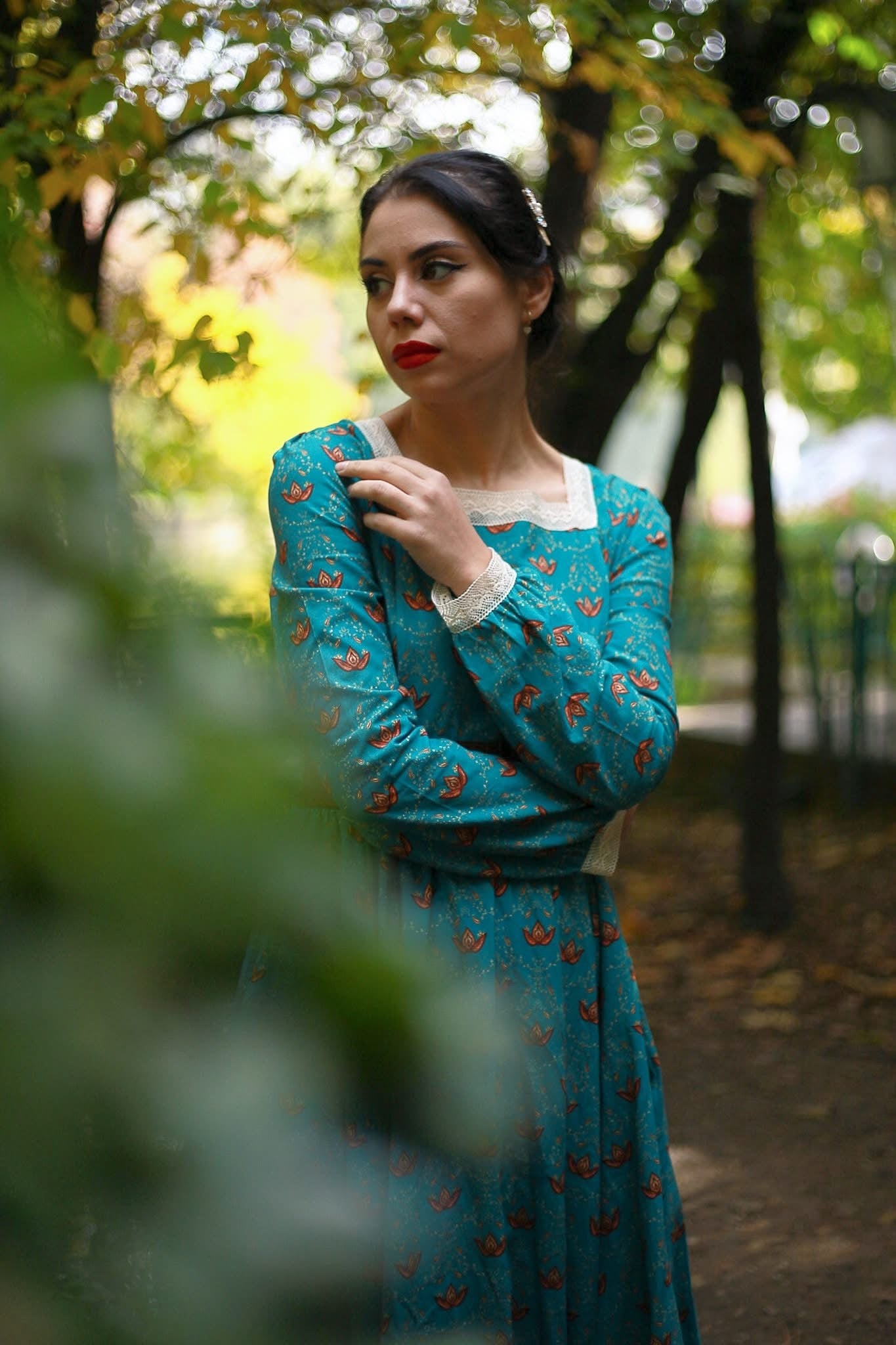 Woman in modest nursing blue dress in park