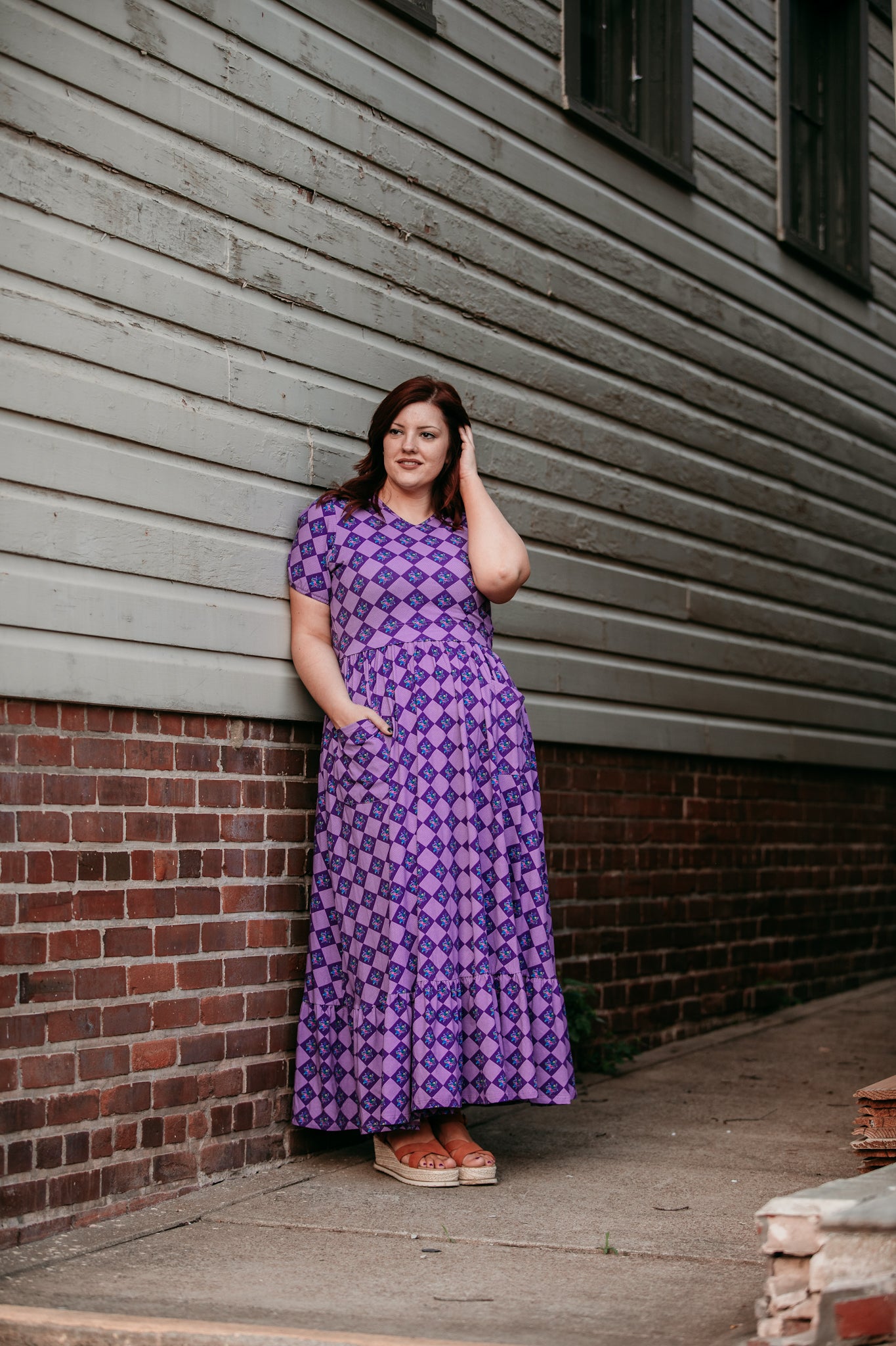 Woman in a purple checkered modest nursing dress.