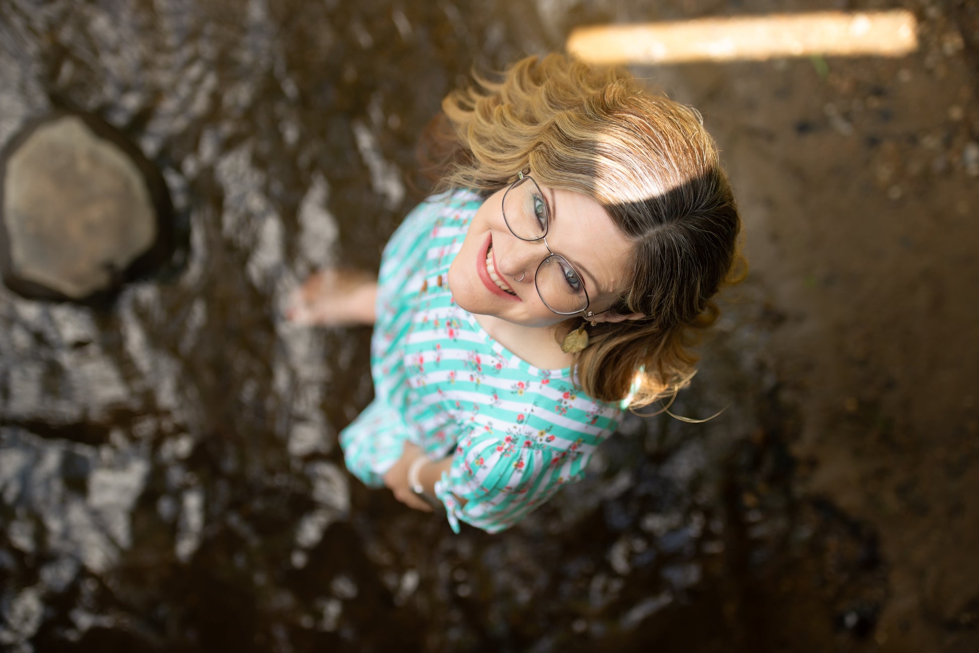 Person wearing a modest nursing dress, looking up.