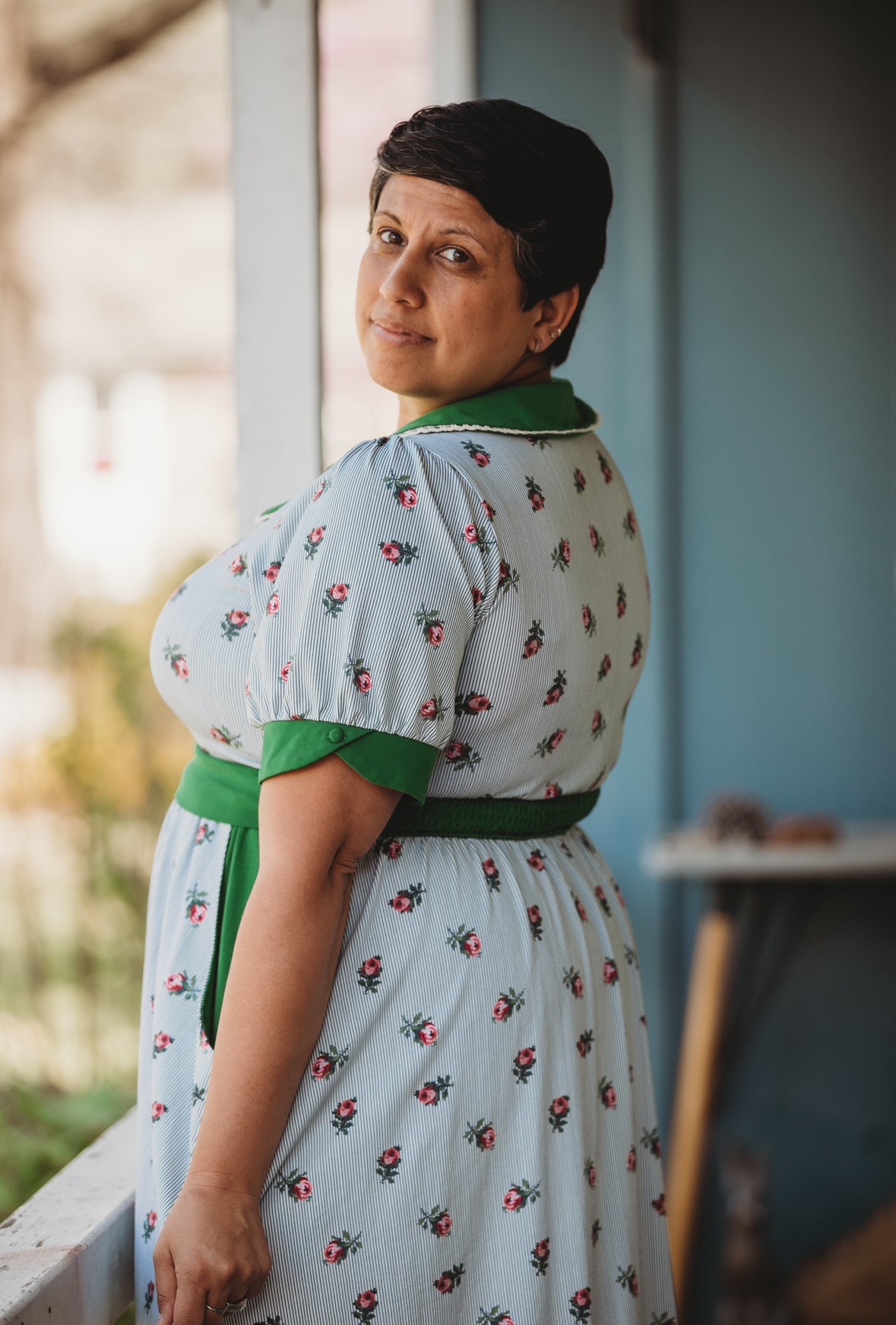 woman wearing a green and white striped modest nursing dress