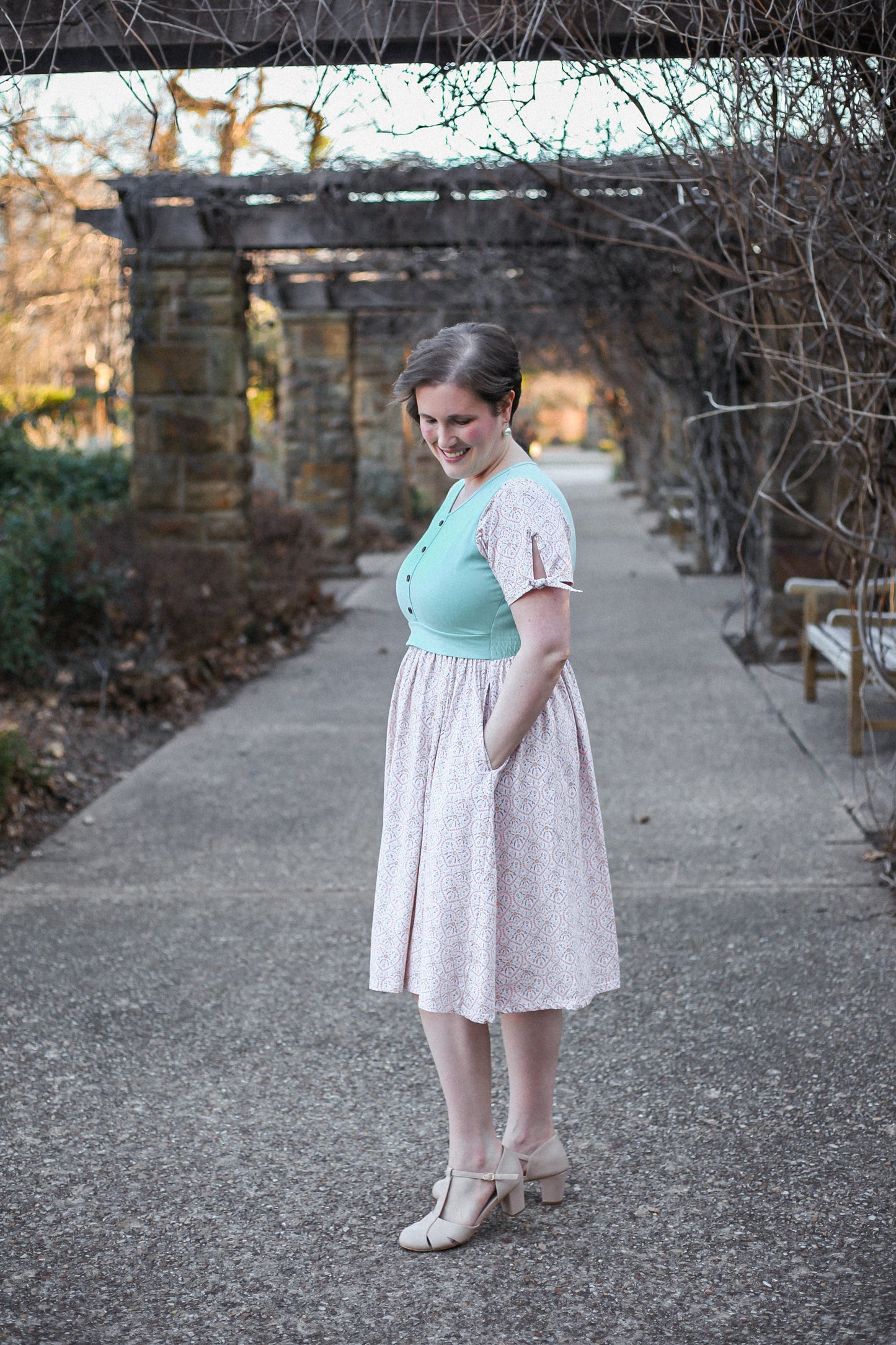 A woman wearing a vintage style modest nursing dress.
