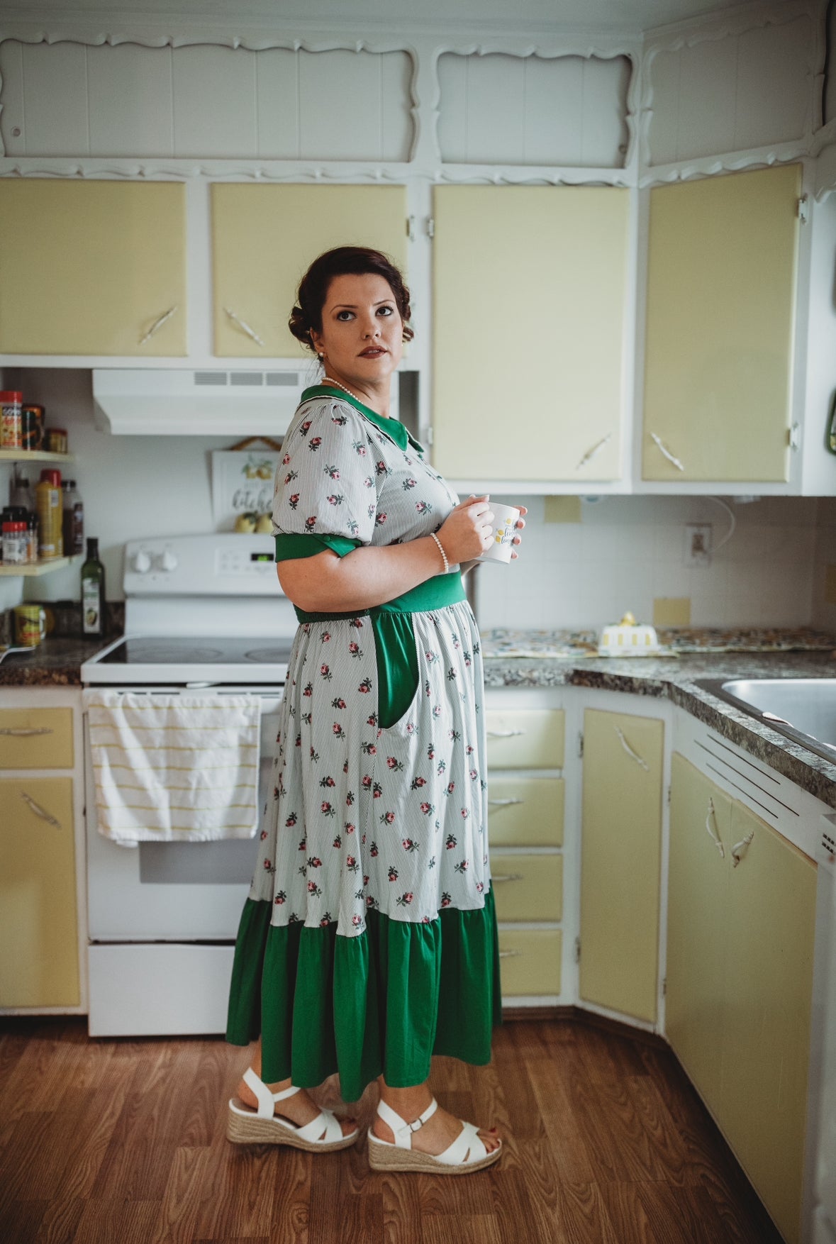 woman wearing a green and white striped modest nursing dress