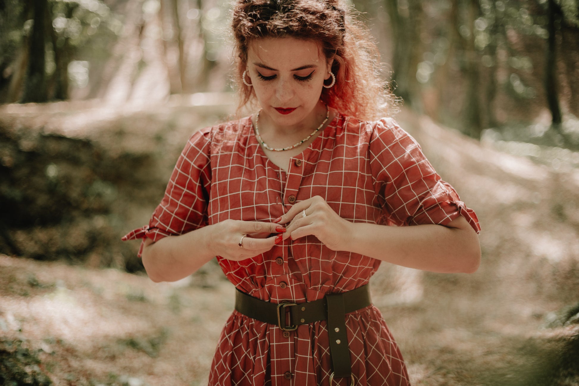 Woman in modest nursing red checkered dress forest