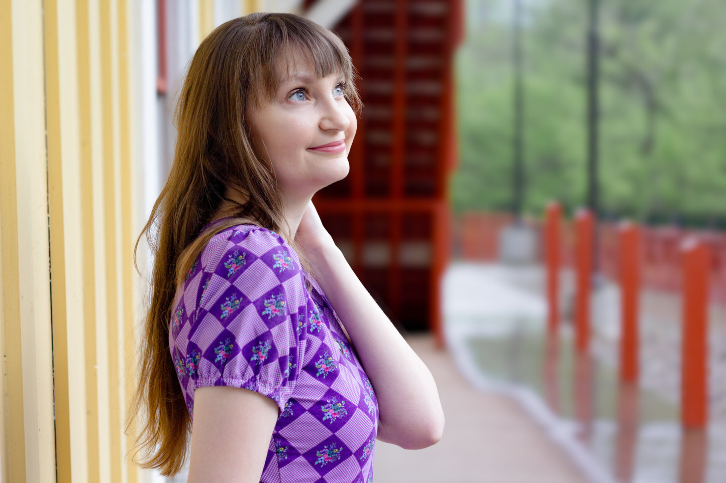 woman wearing patterned purple modest nursing dress