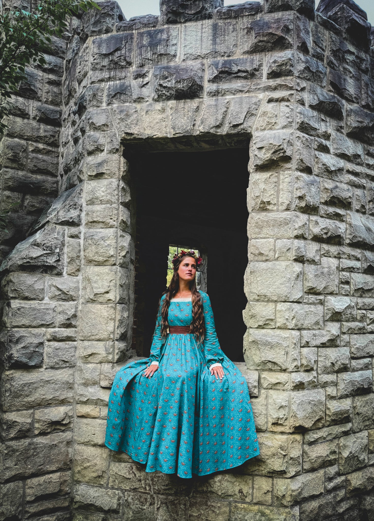 Woman in modest nursing blue dress in archway