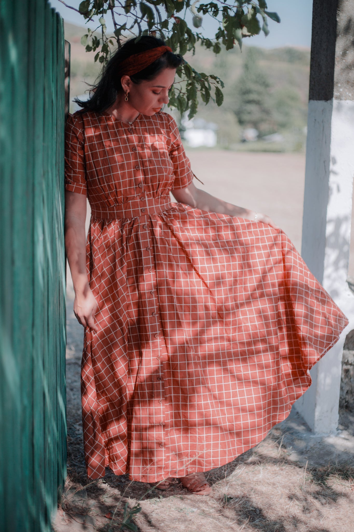 Woman in modest nursing plaid dress outdoors