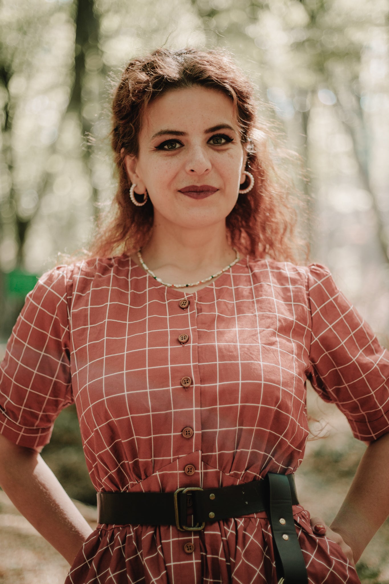 Woman in modest nursing red checkered dress forest