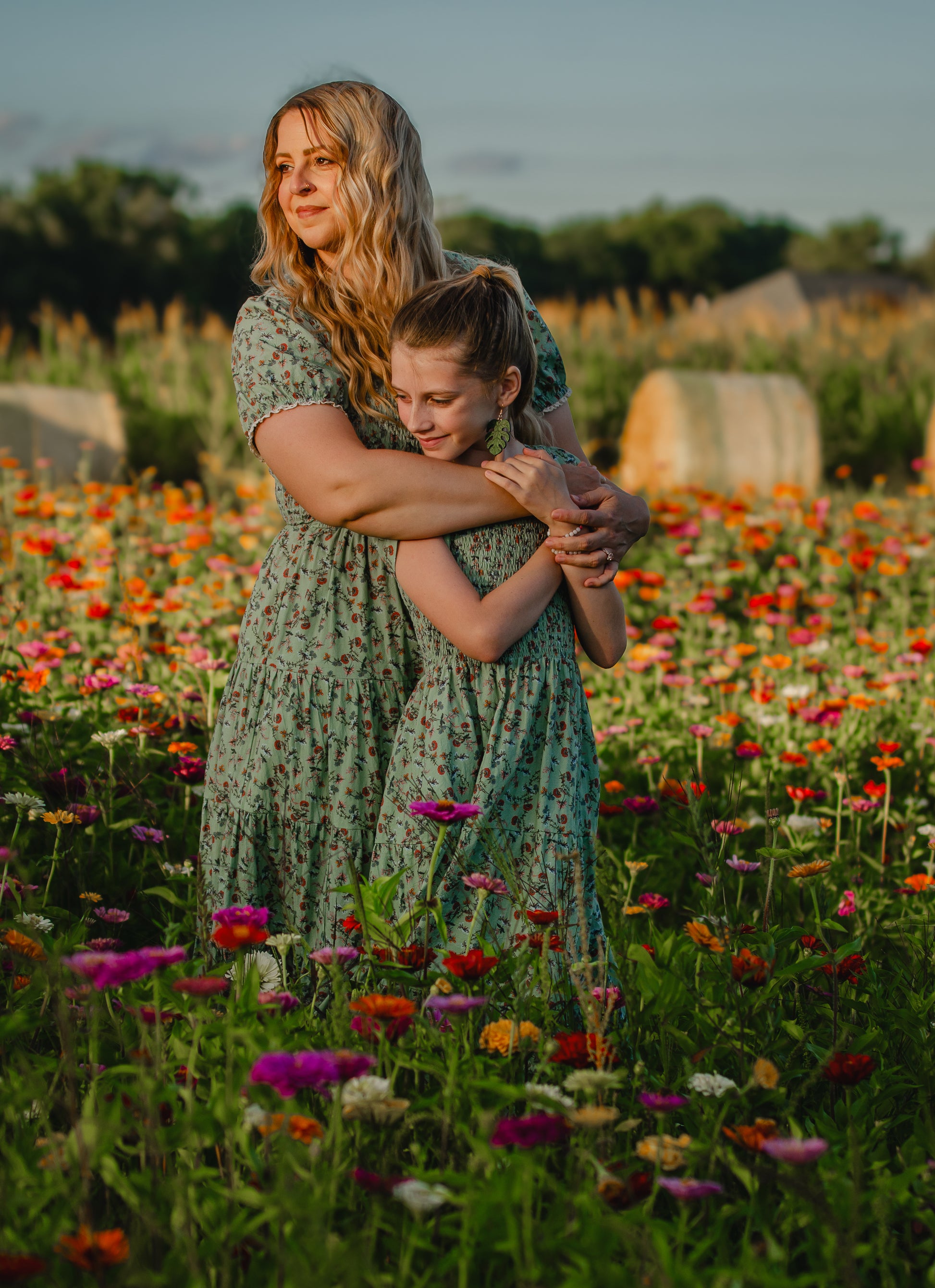 woman wearing a modest nursing green floral dress with her daughter