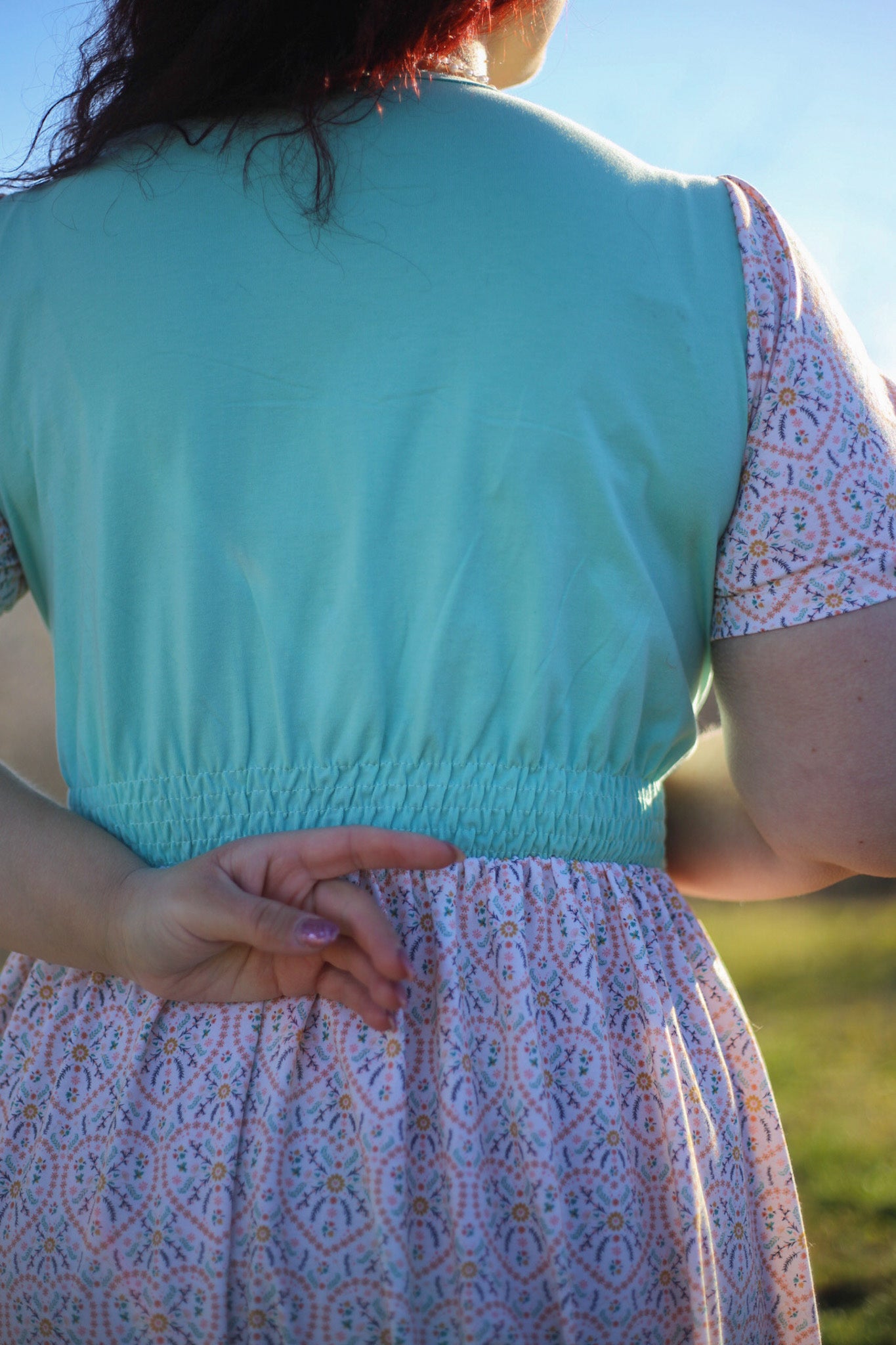 A woman wearing a vintage style modest nursing dress.