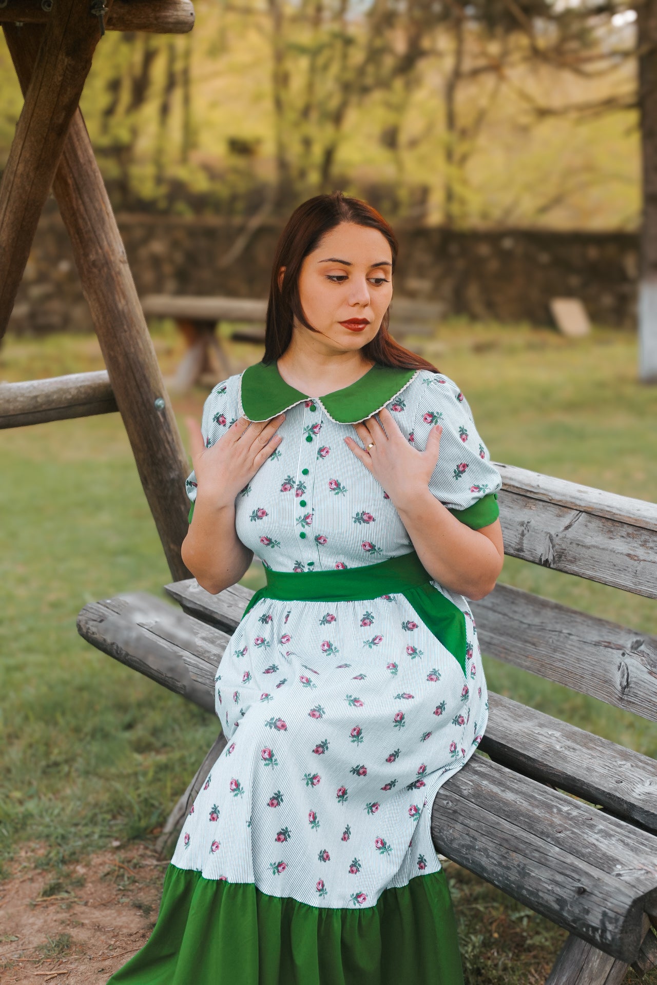 woman wearing a green and white striped modest nursing dress