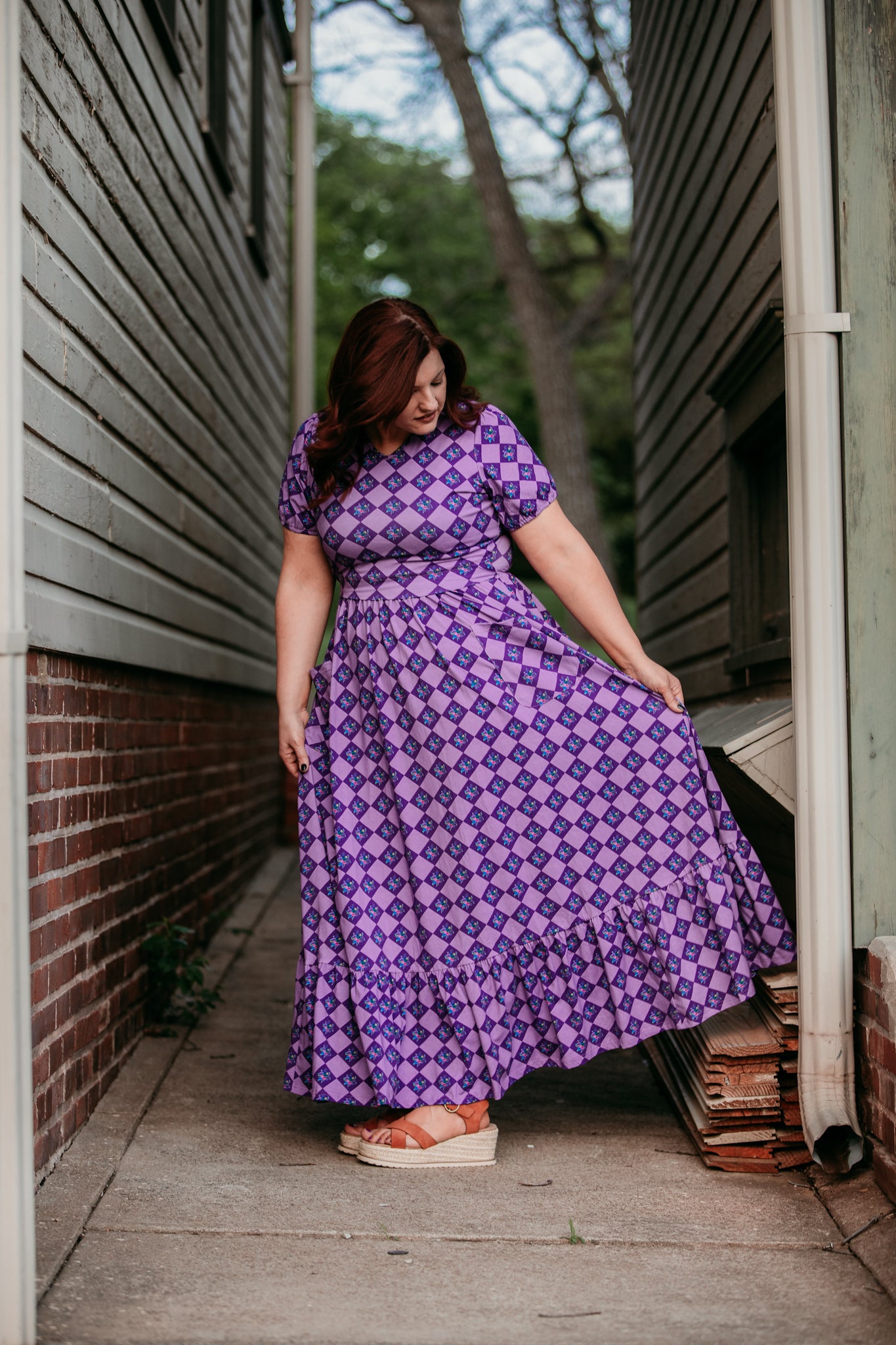 Woman in a purple checkered modest nursing dress