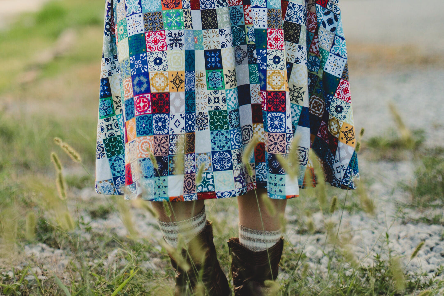 Colorful patchwork modest nursing dress with patterned fabric in a natural setting