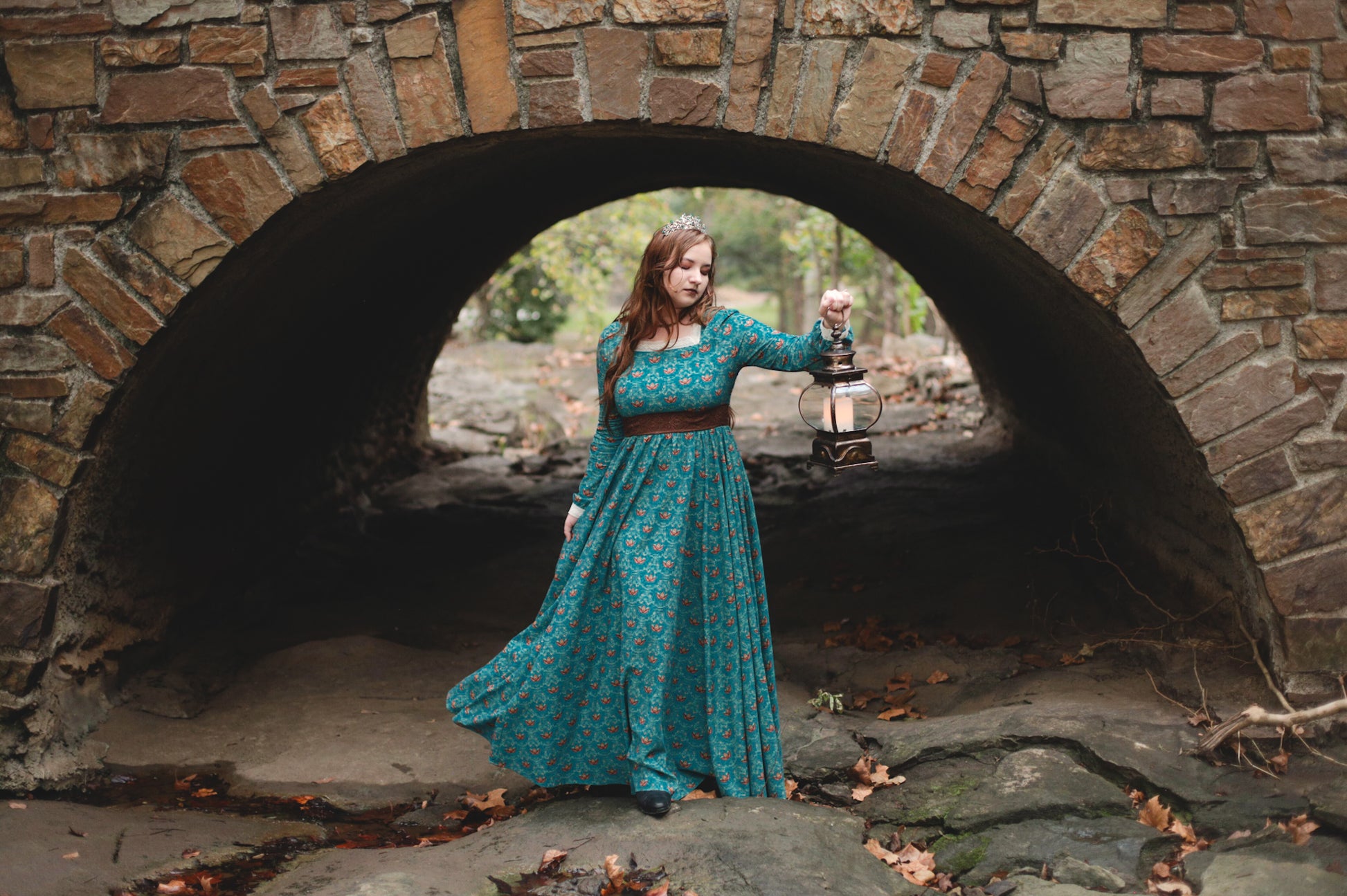 Woman in modest nursing teal dress in archway