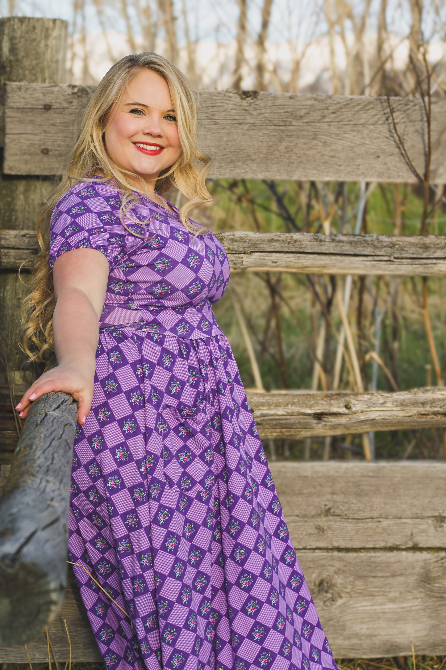 woman wearing patterned purple modest nursing dress