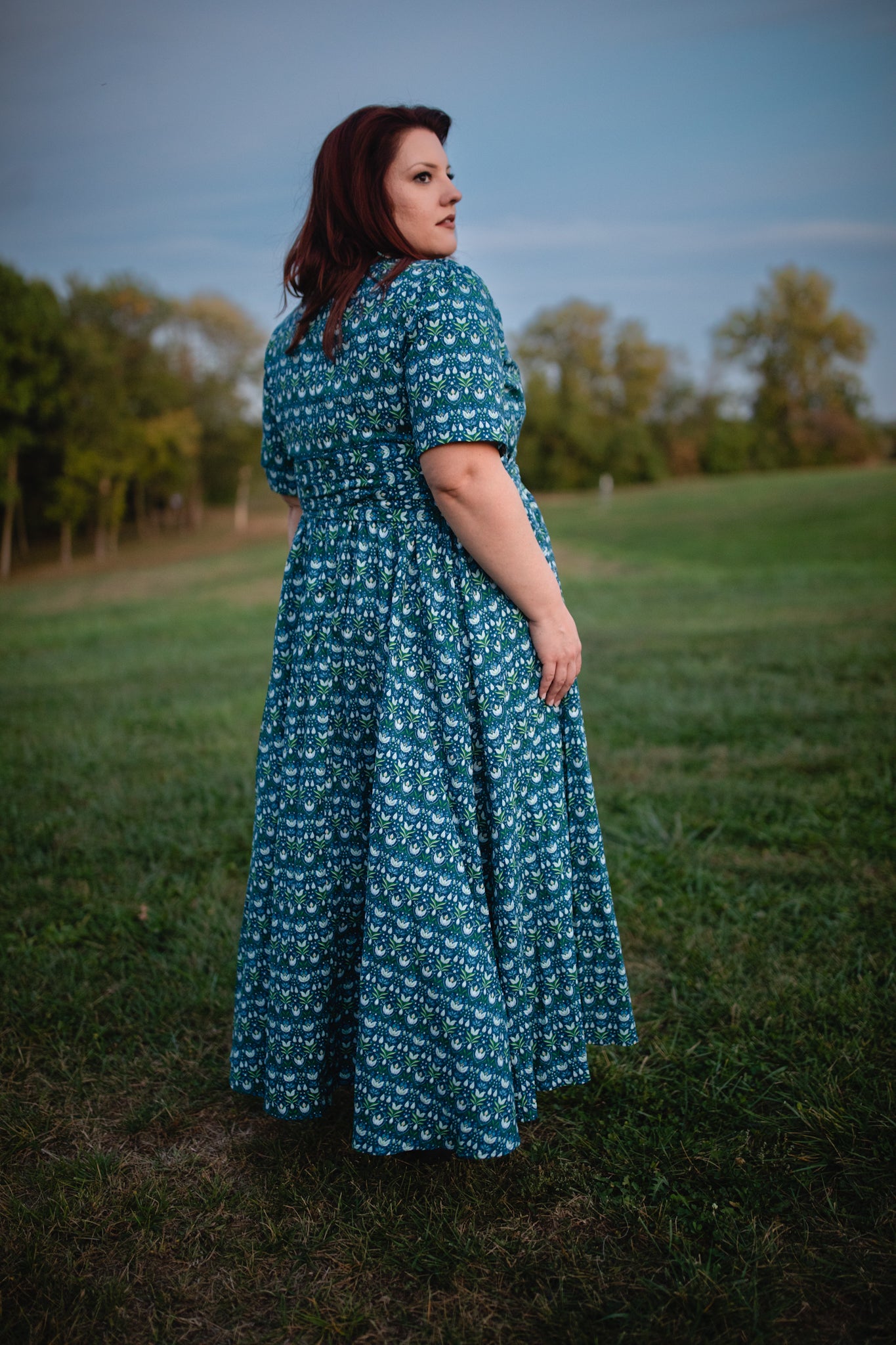 Woman in modest nursing dress in field