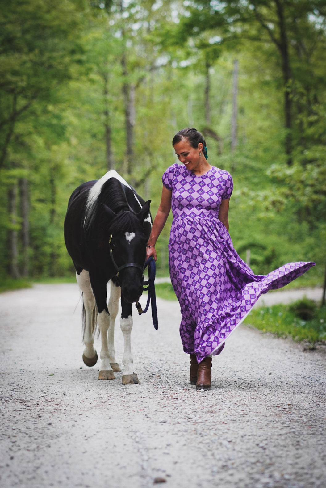 Woman in a purple checkered modest nursing dress.