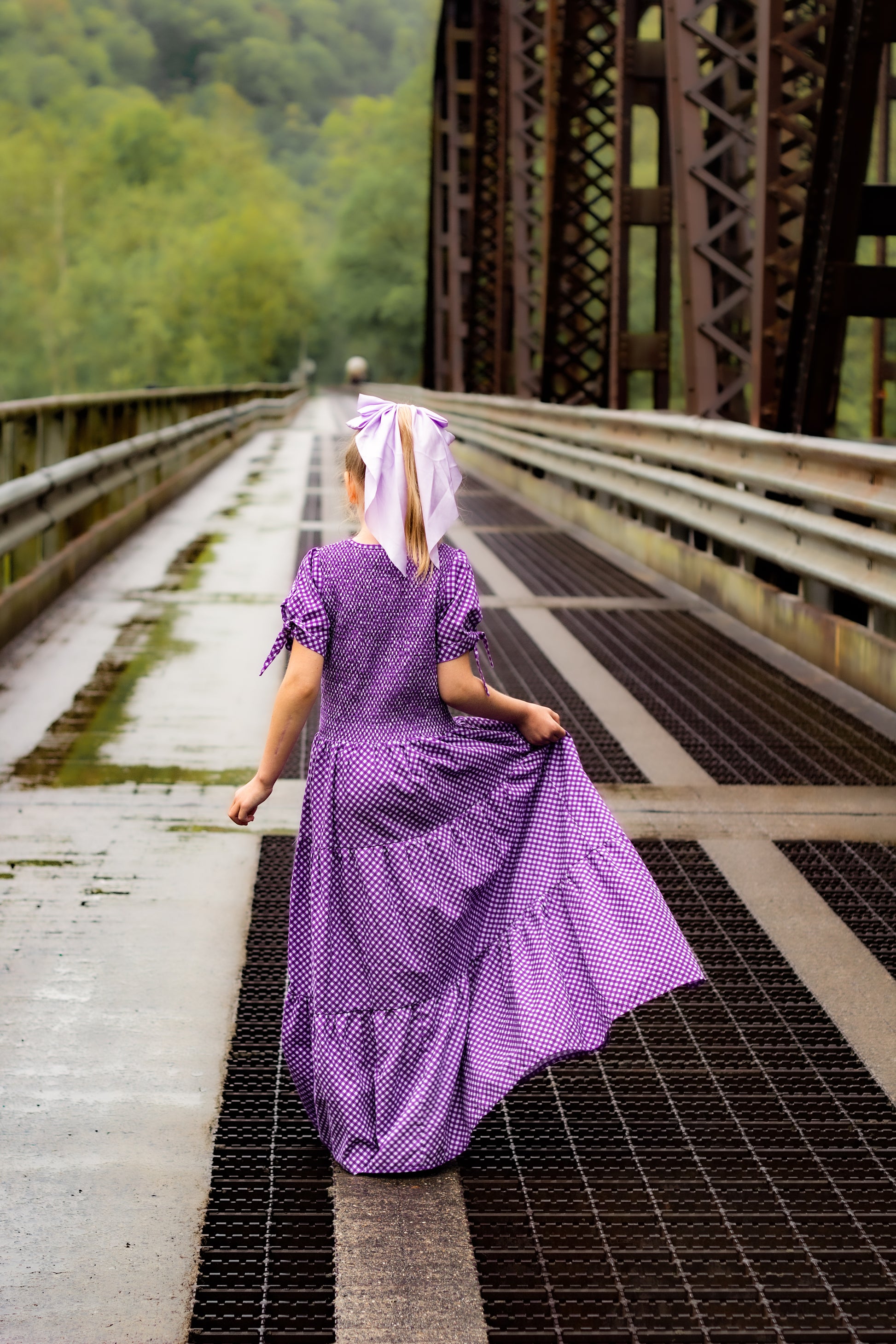 Young girl wearing a modest purple dress