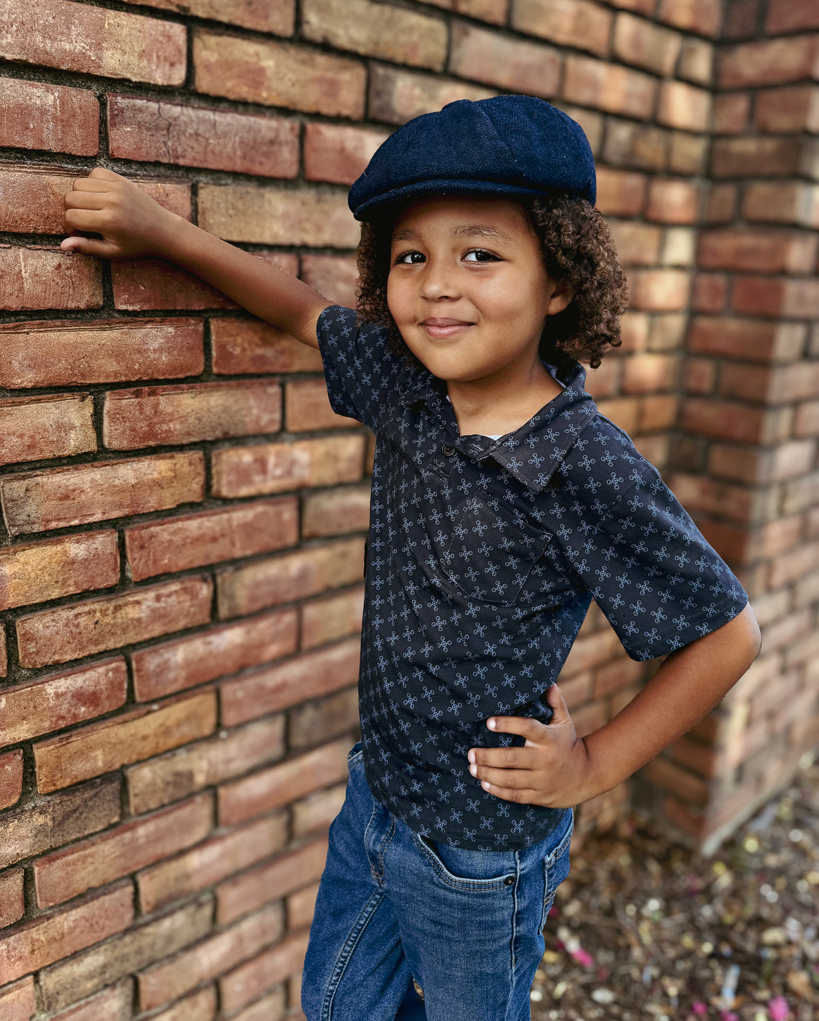 Young boy wearing a dark blue polo shirt